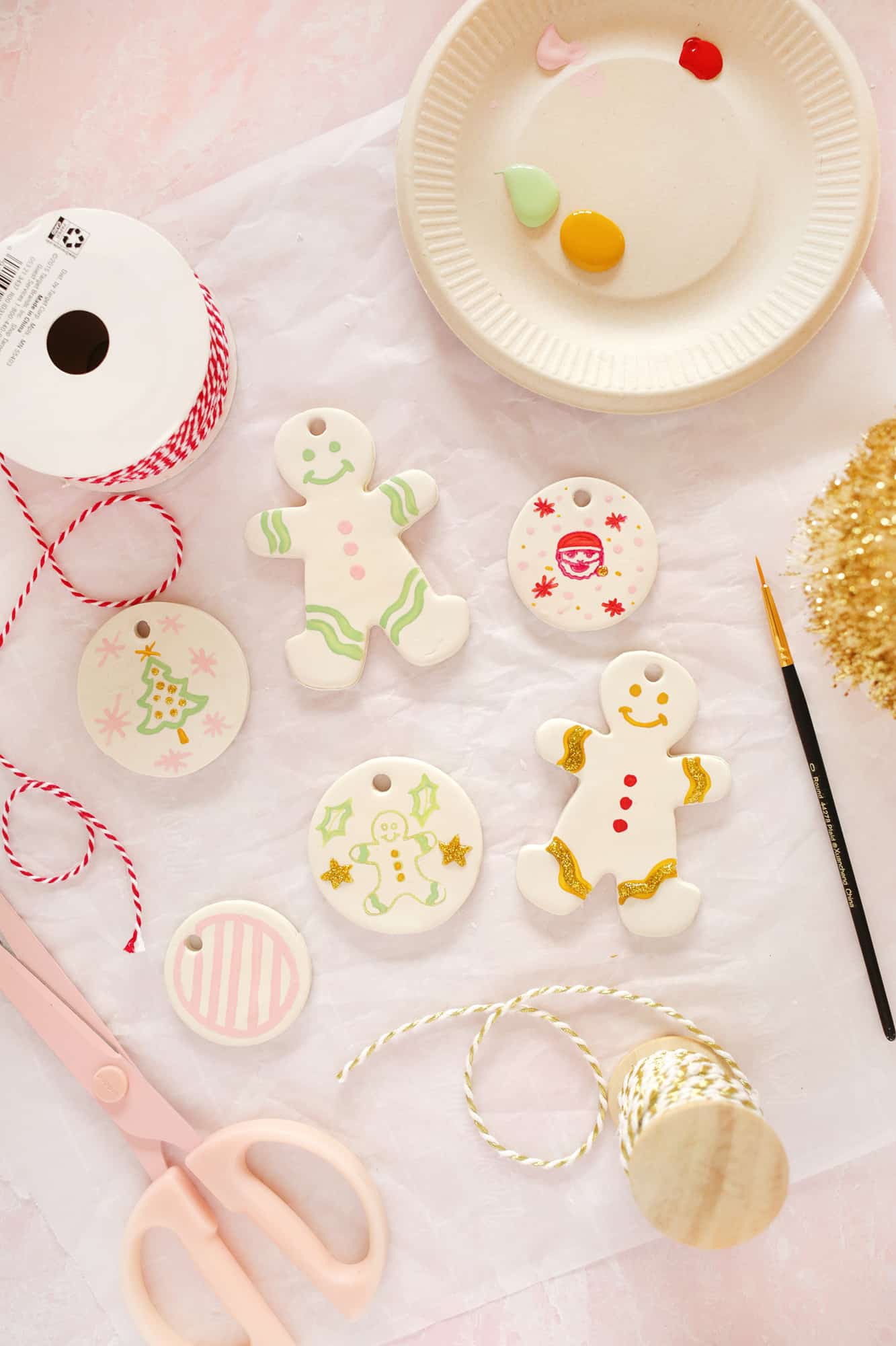 painted gingerbread people and circle ornaments made from clay 