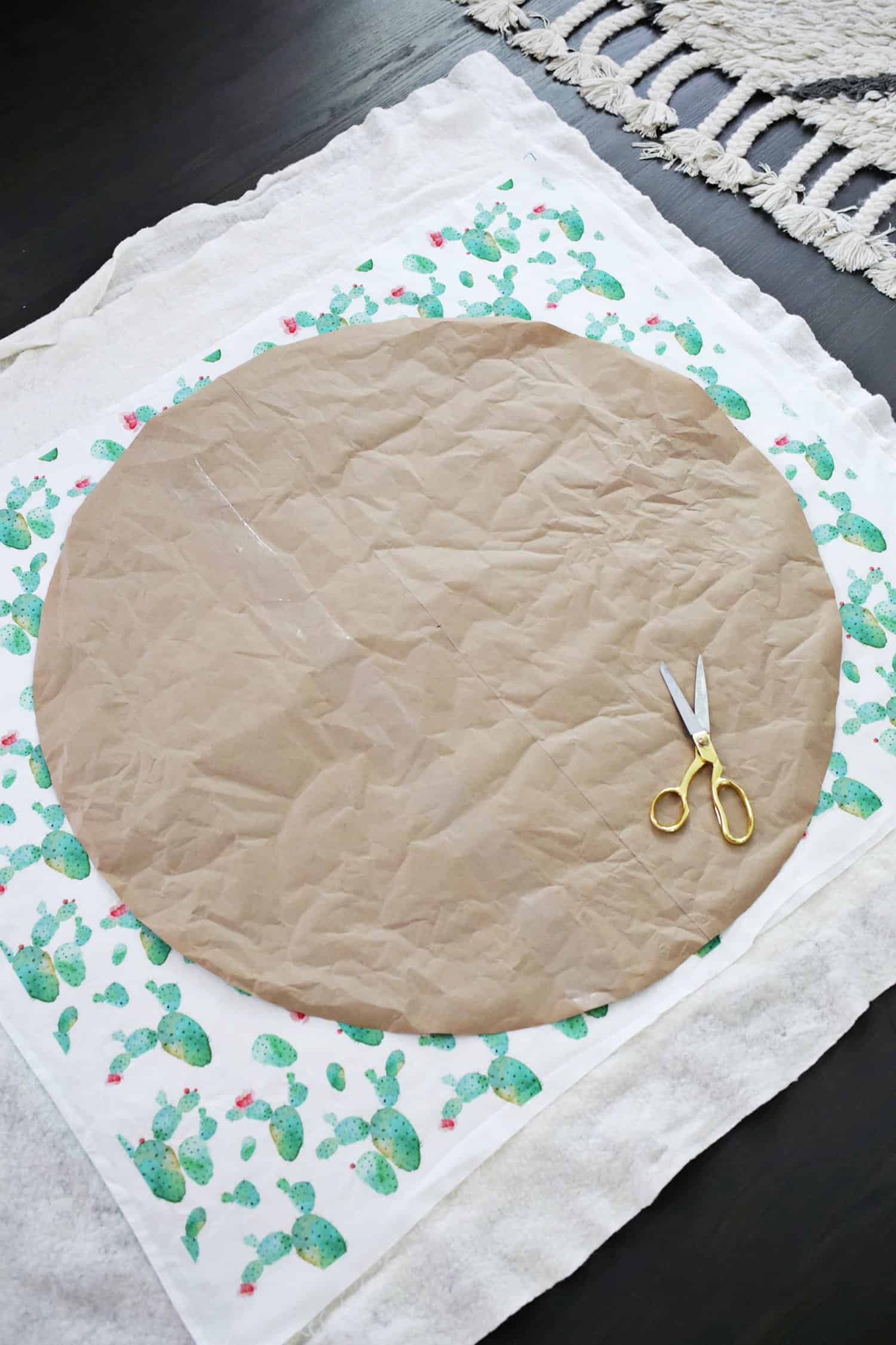 circle shaped parchment paper on catcus fabric with gold scissors