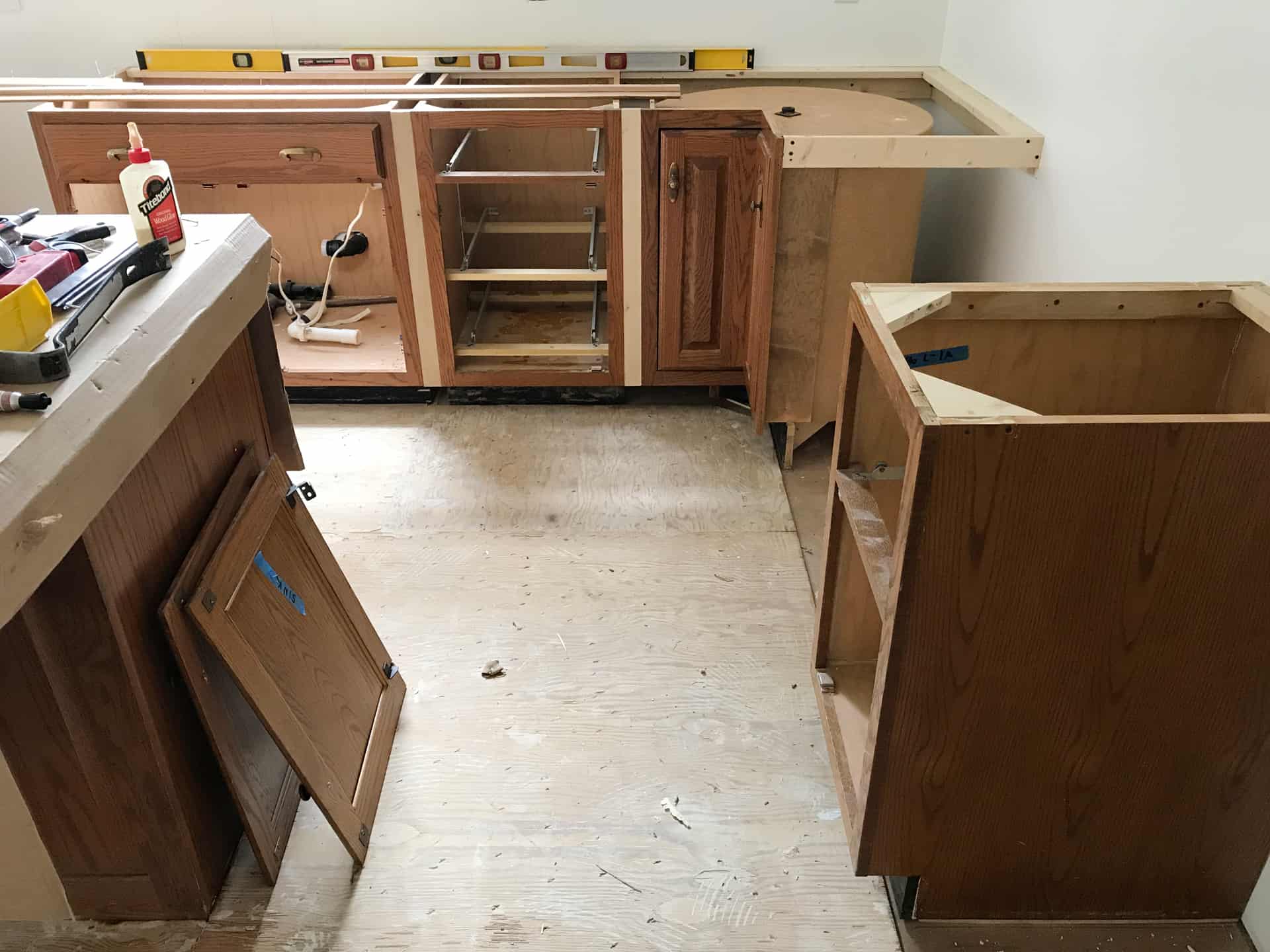 brown kitchen cabinets with no doors or countertop