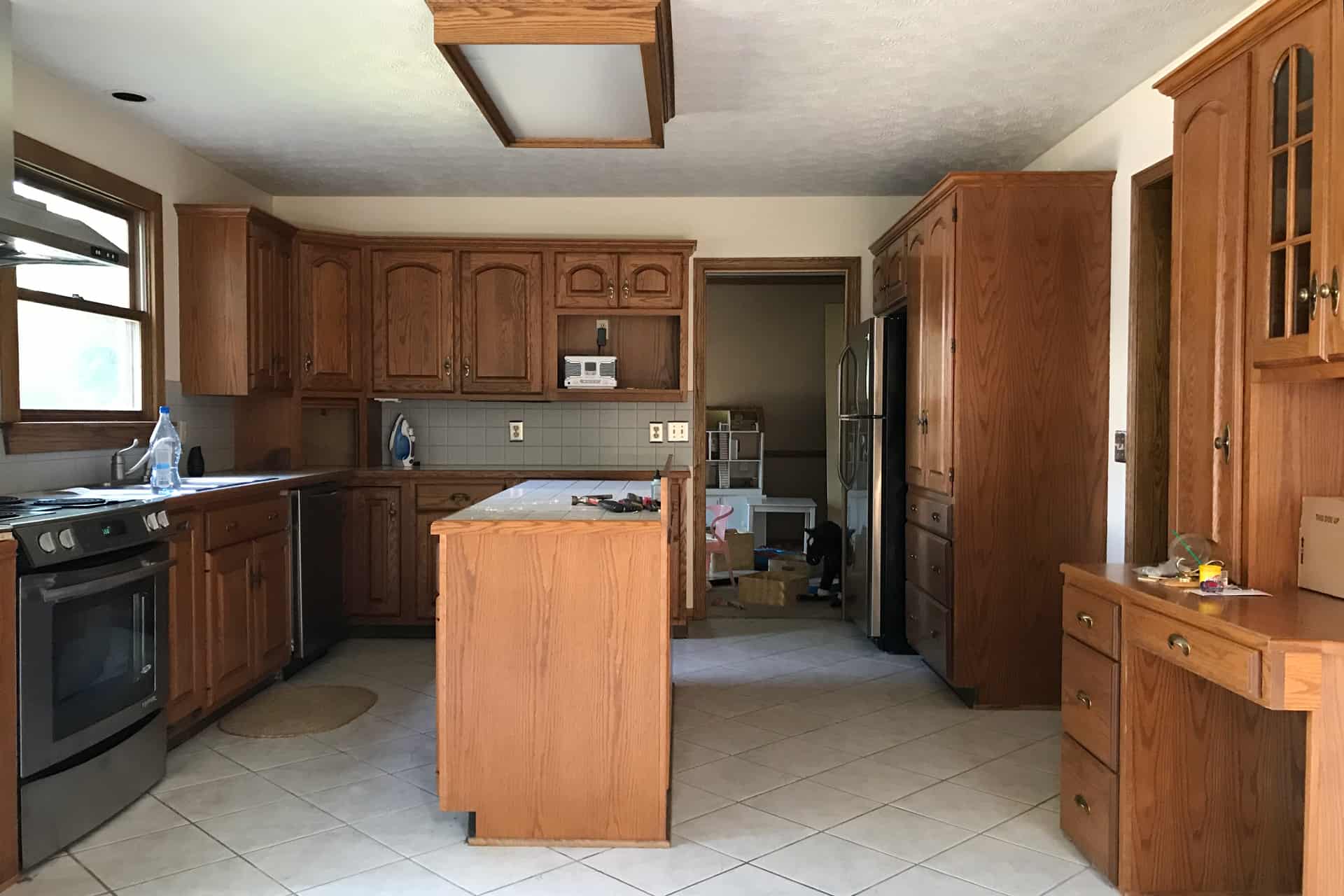 kitchen with brown cabinets, an island, and tile floor