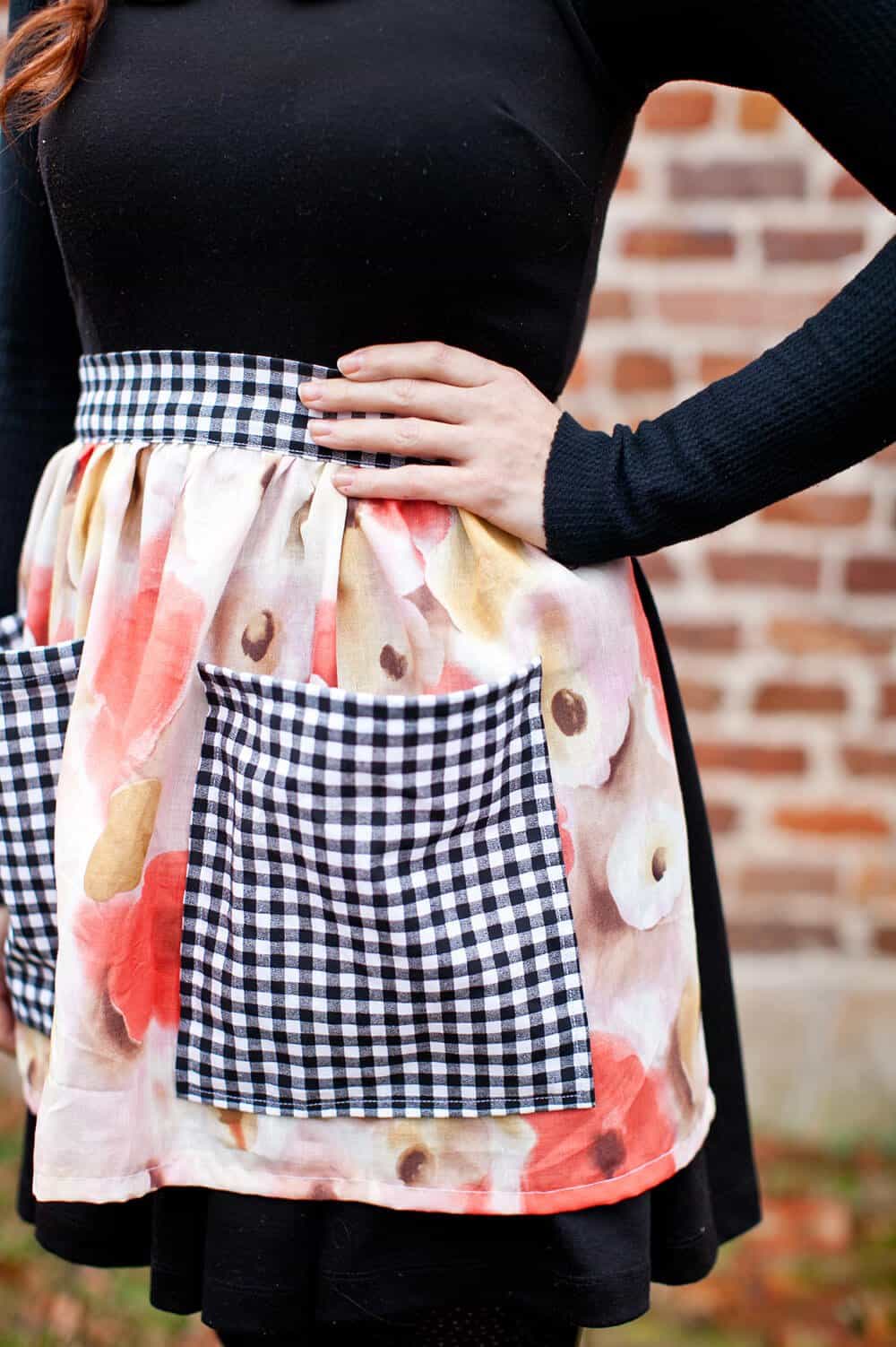 a close up of a flower apron with black and white checkered pockets