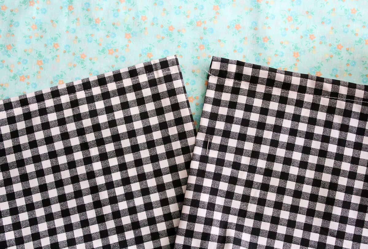 2 square pieces of black and white checkered fabric