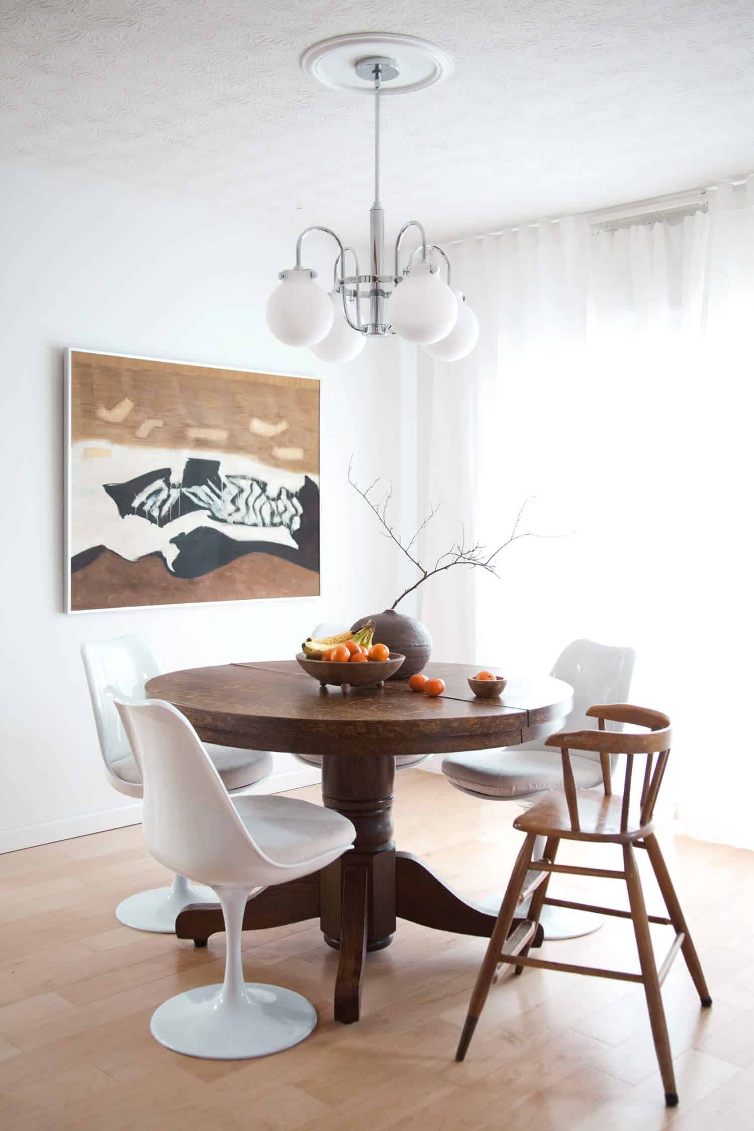 Antique pedestal table with modern tulip chairs