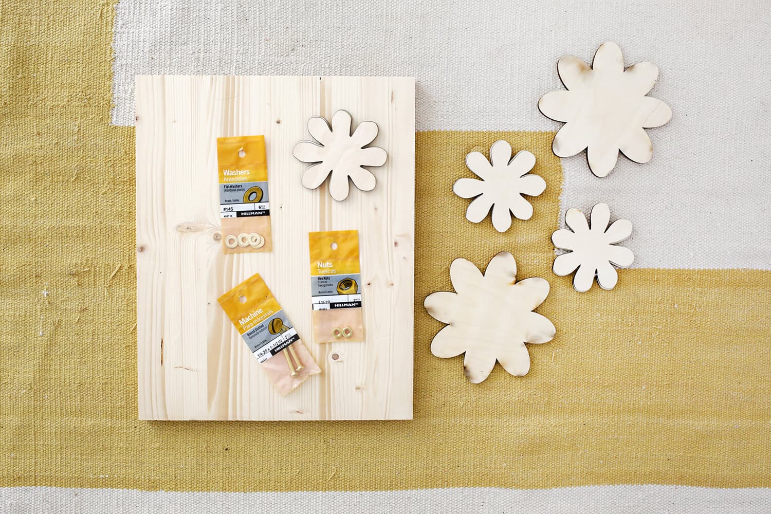 wooden board with wooden cut out flowers next to it