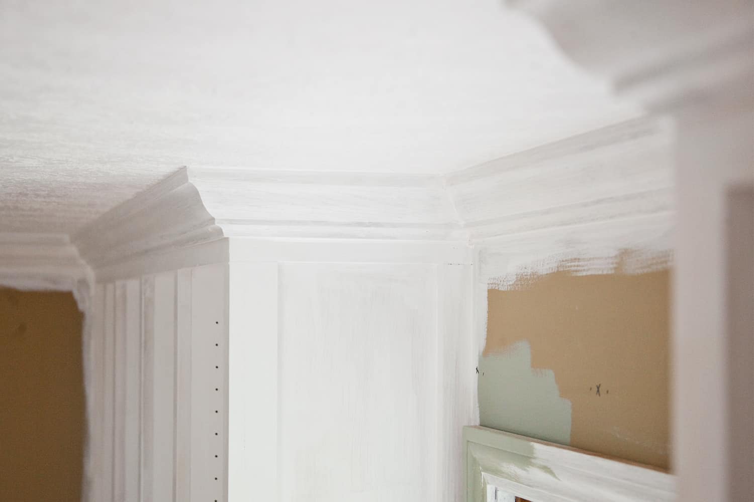 bookcase with molding on top by ceiling