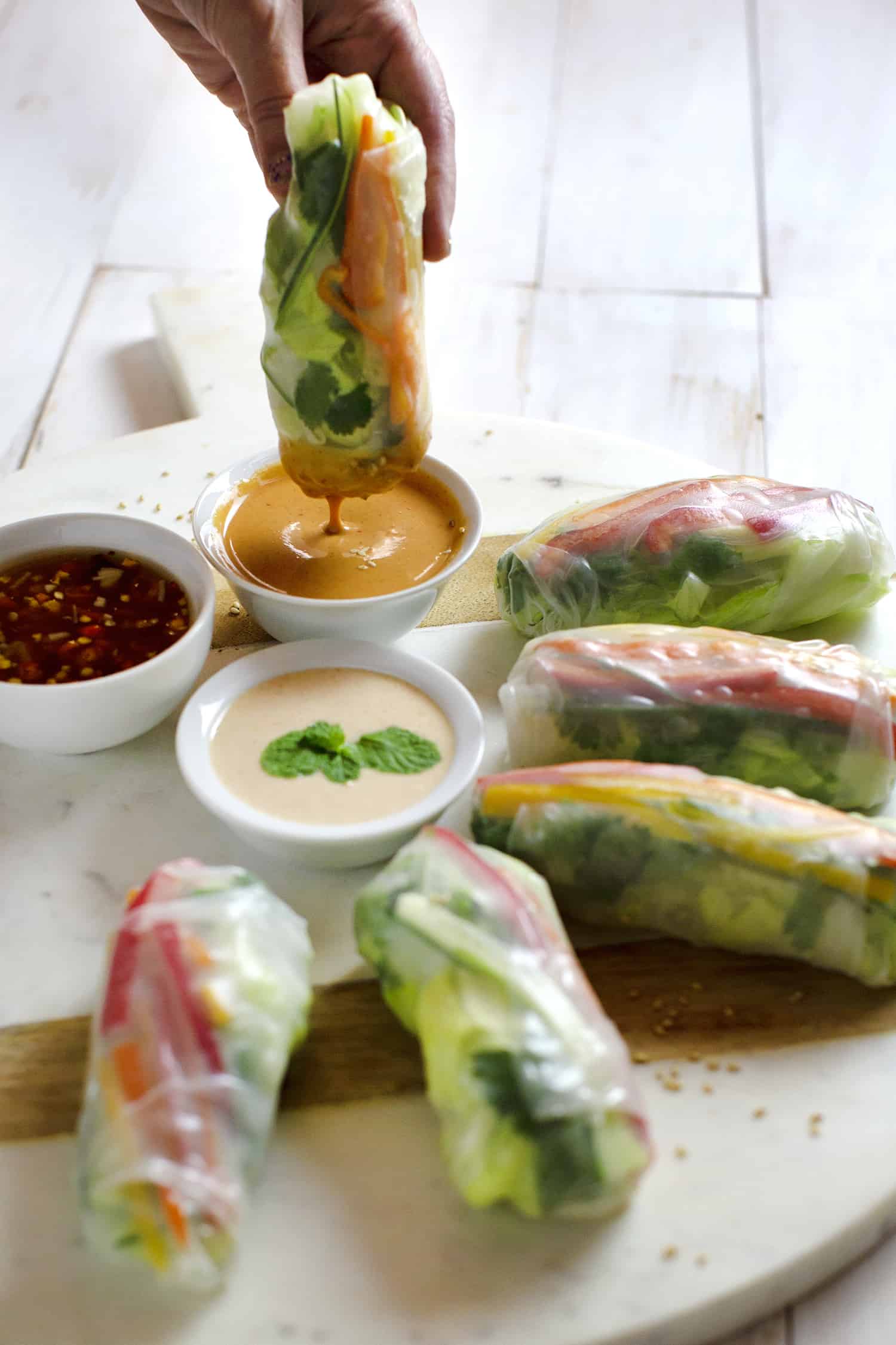 dipping spring roll into sauce