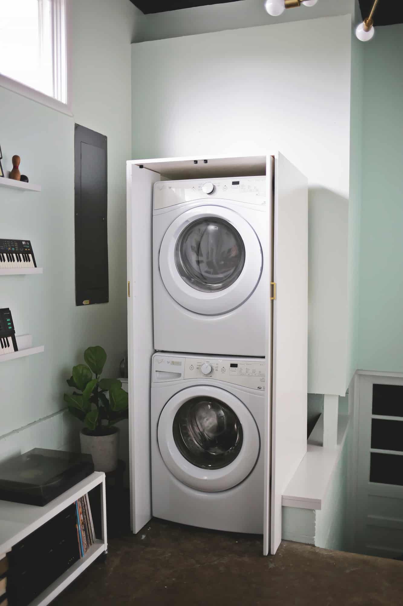 white cabinet with stacked washer and dryer in it