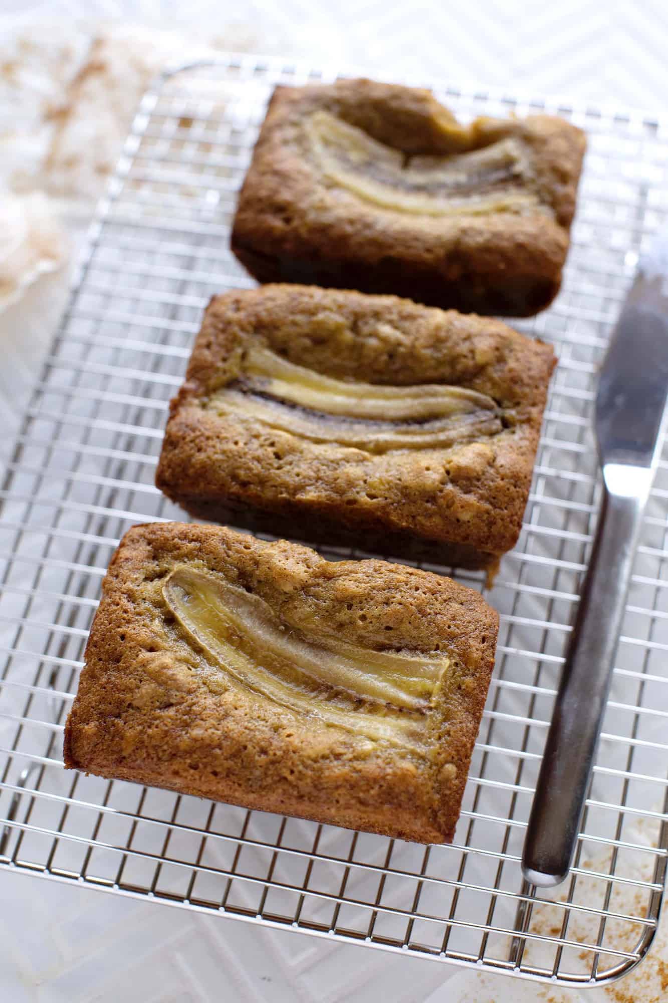 3 loaves of banana bread on a cooling rack