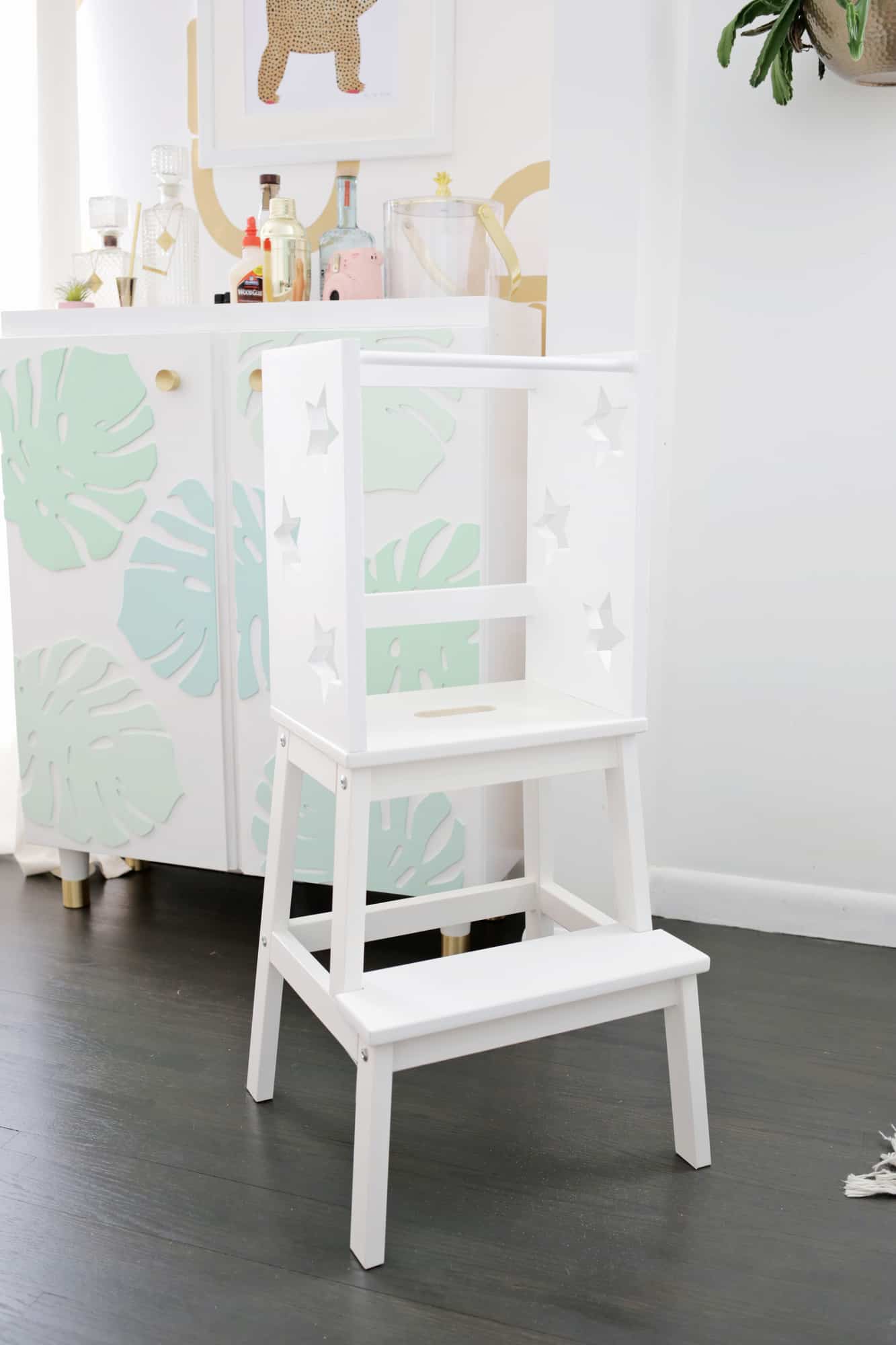 a white step stool with box with stars cut out on top
