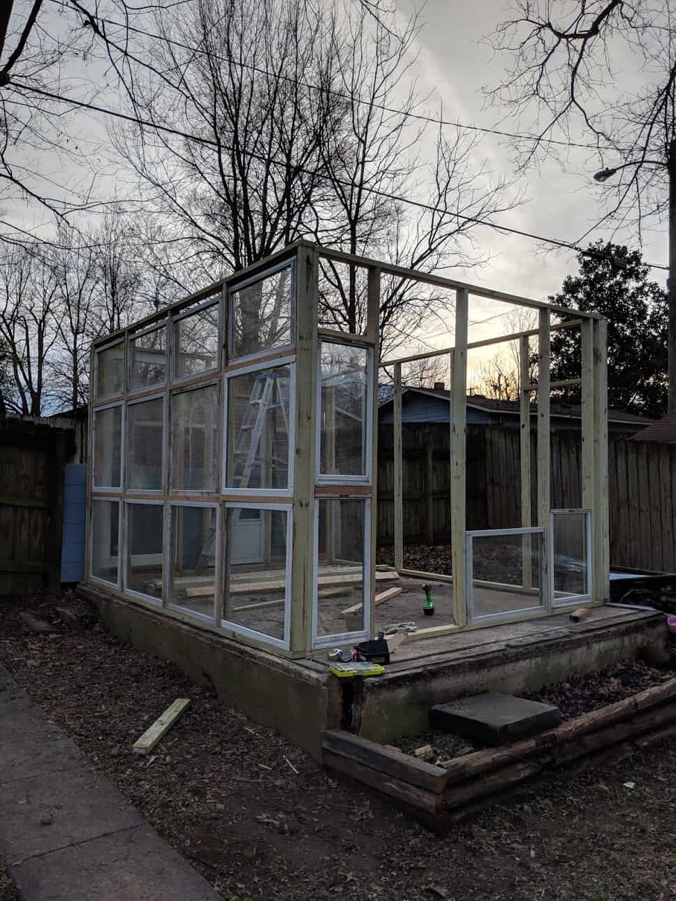 woos frame of greenhouse with old windows in it