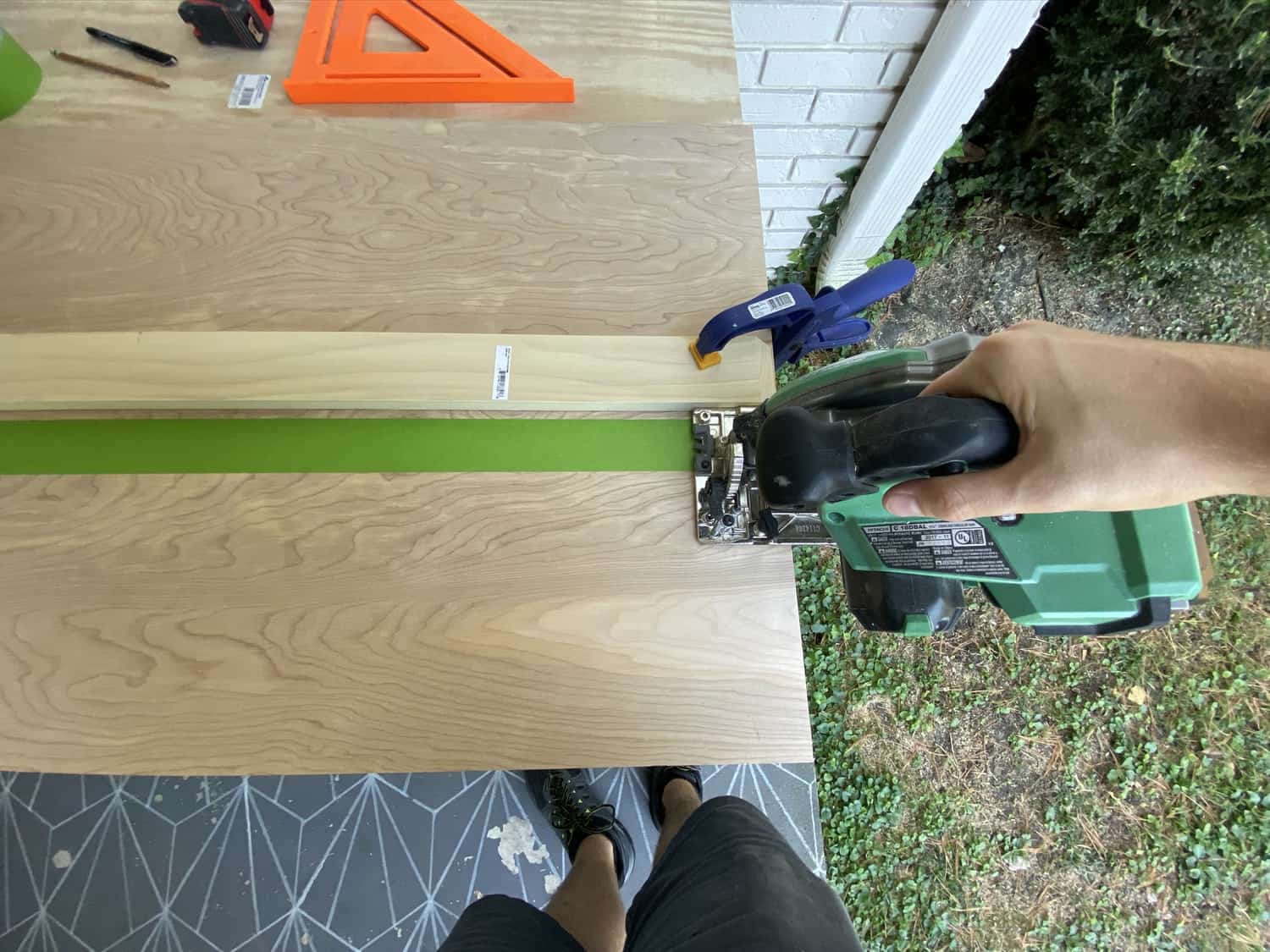 someone cutting pieces of plywood