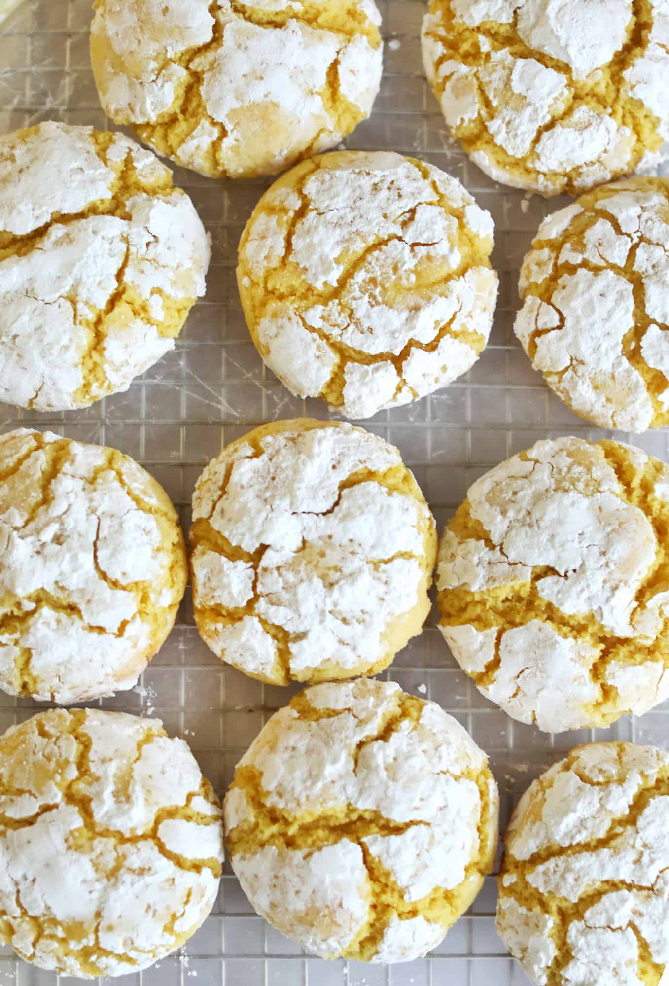 lemon burst crinkle cookies on a cooling rack