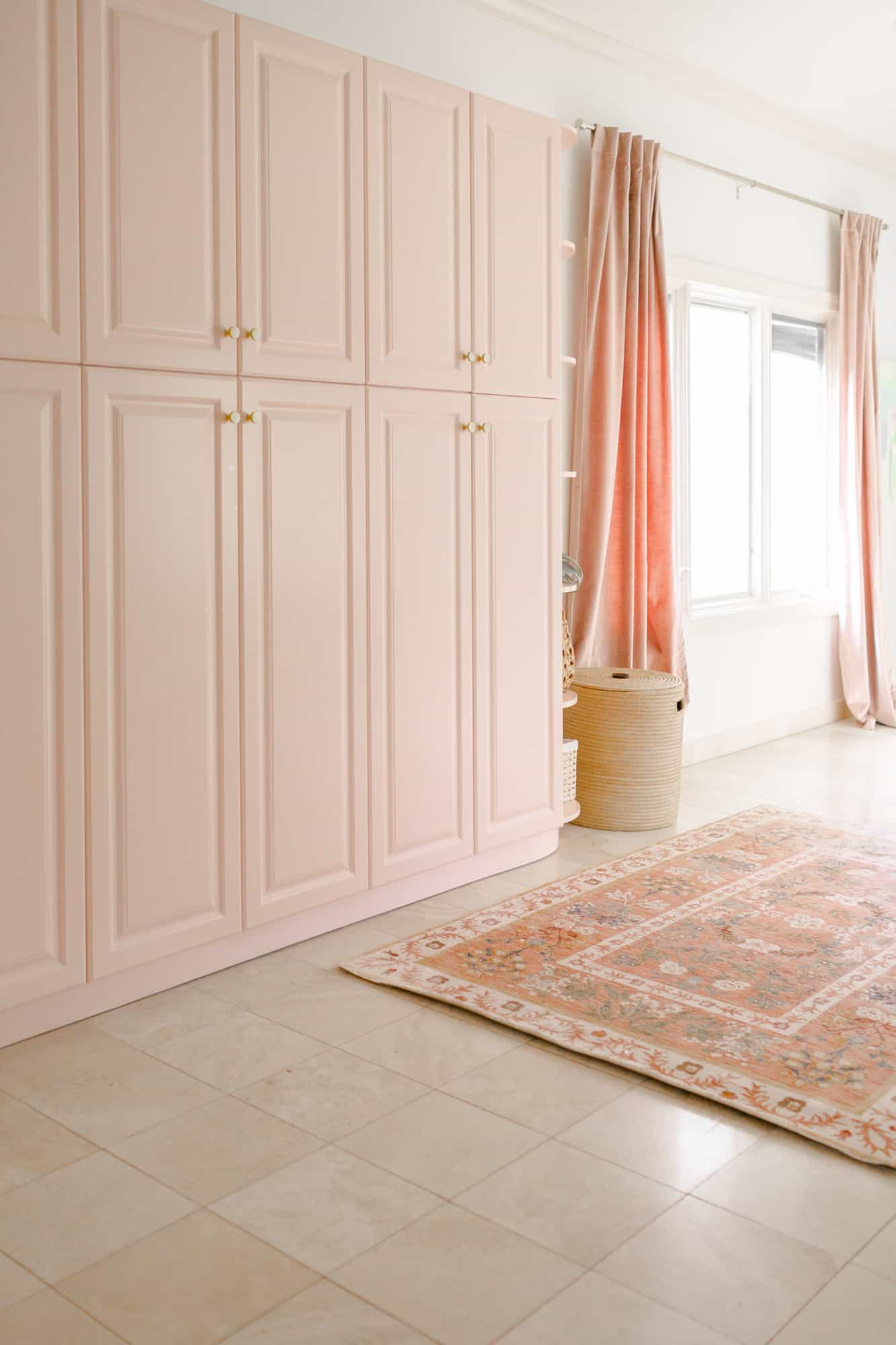 floor to ceiling pink cabinets with a pink rug in front of it