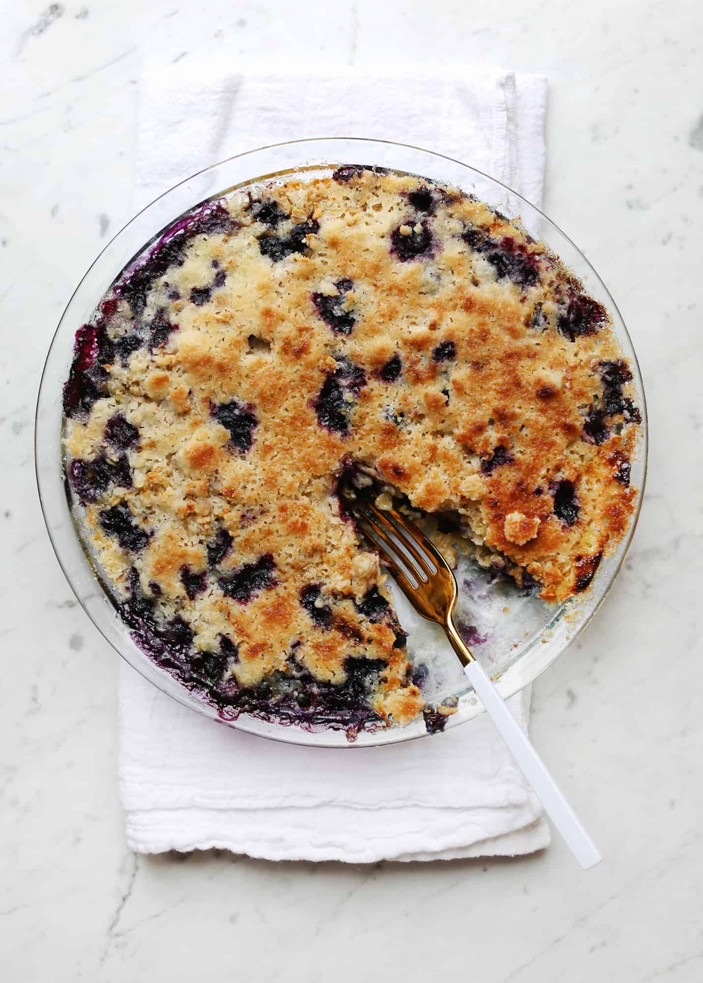 Overnight baked blueberry muffin oatmeal with a fork and a bite missing