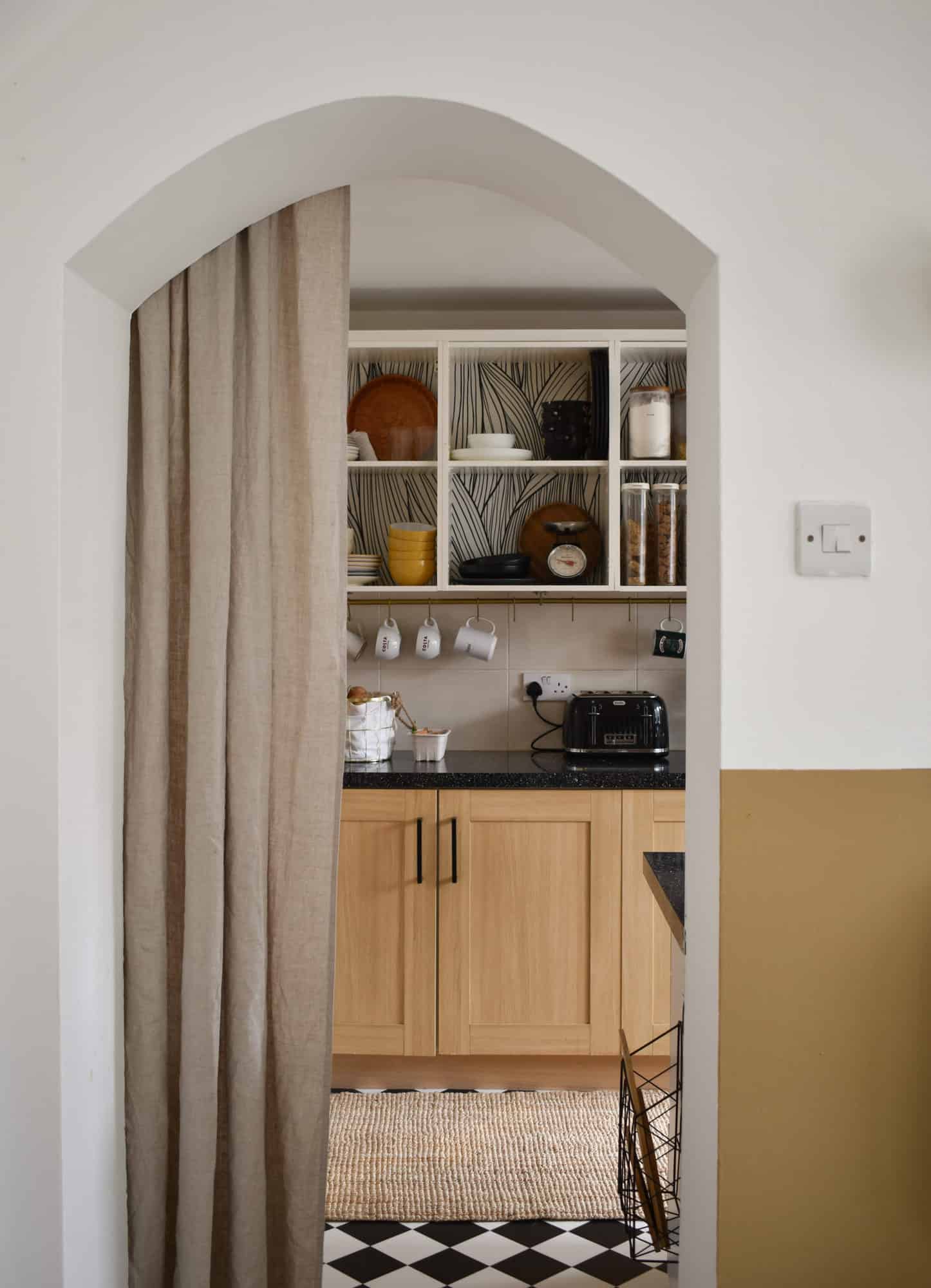 open cabinets in a kitchen with peel and stick wallpaper on the back wall of the cabinet