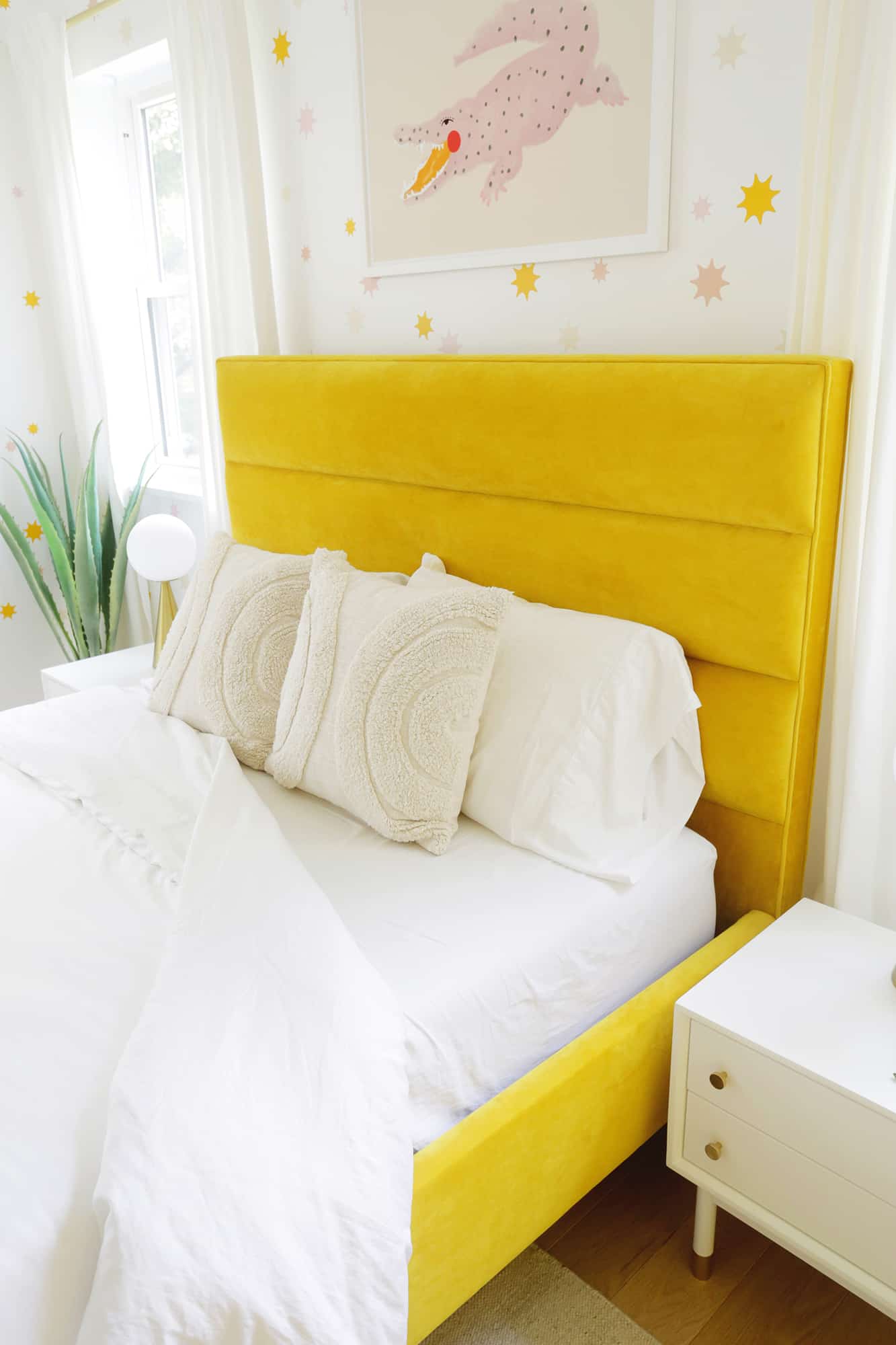 yellow velvet bed with covers pulled back