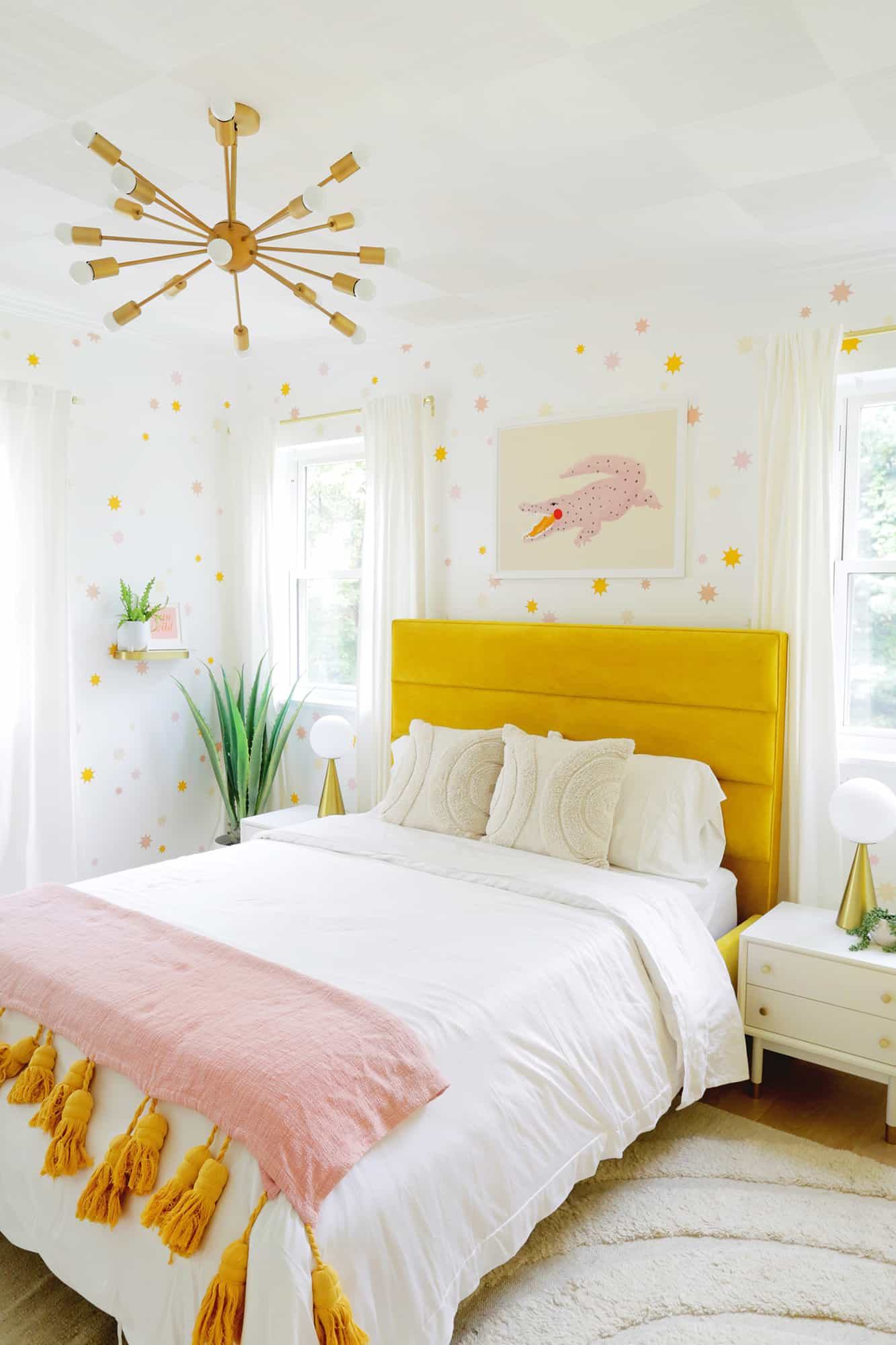 velvet bed frame with pillows and star wallpaper