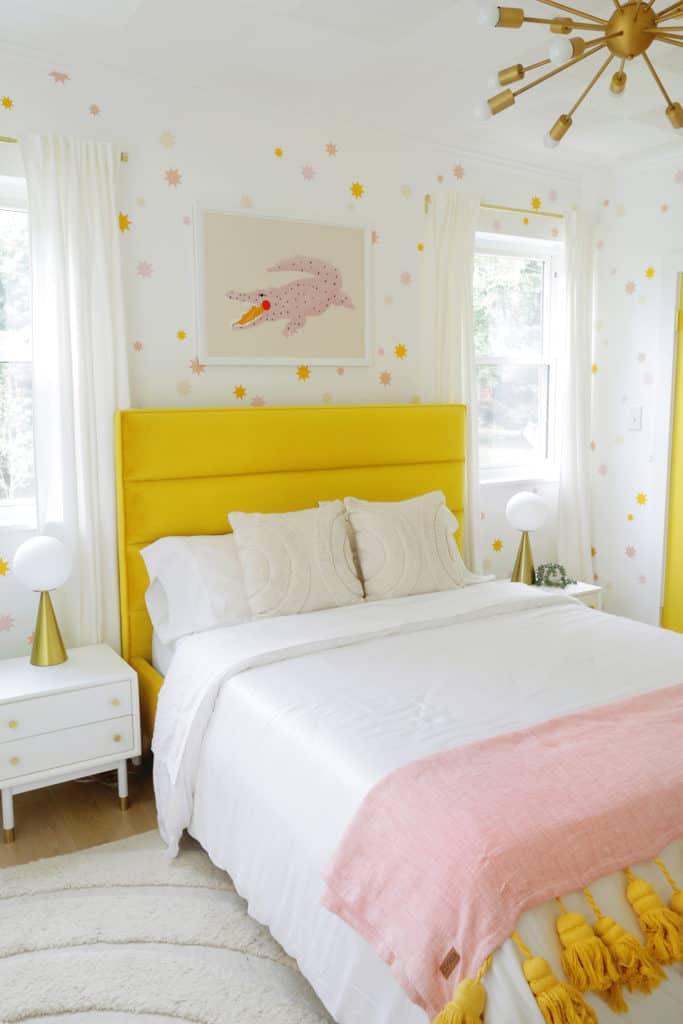 yellow velvet bed with pillows and throw blanket