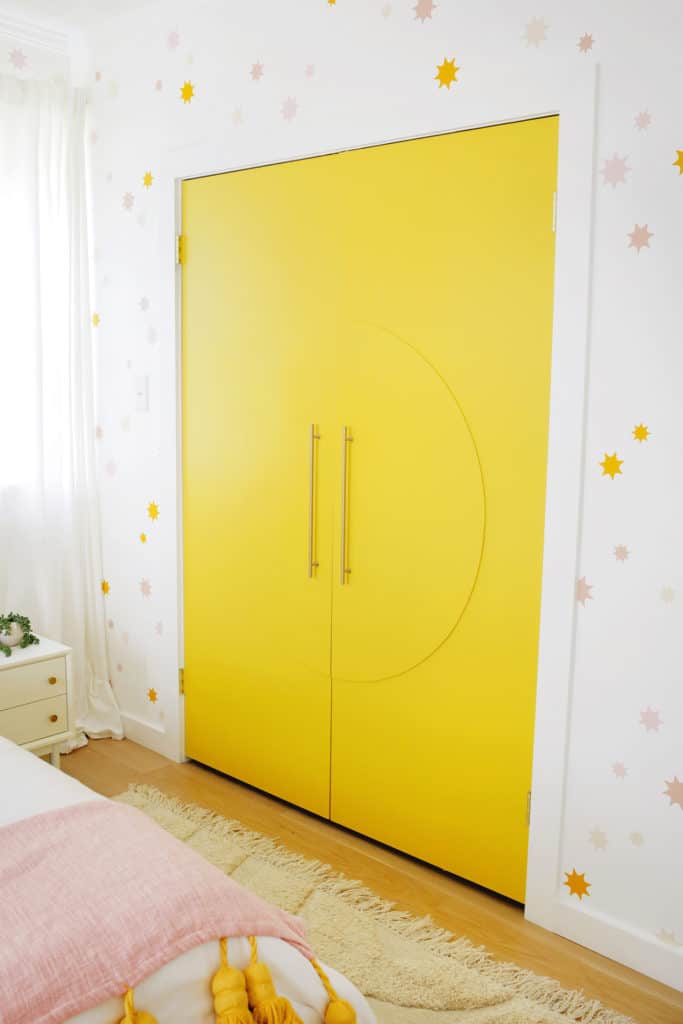 yellow closet doors with circle wood detal