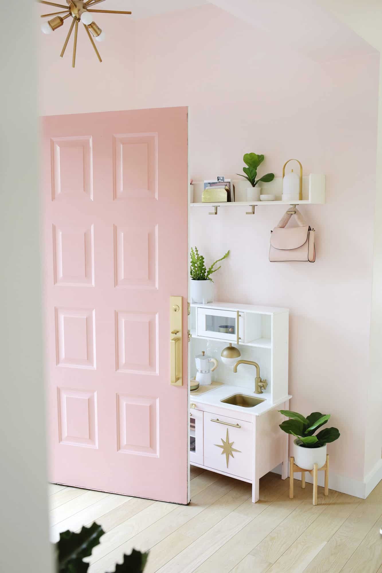 Pink door opening into a pink entryway
