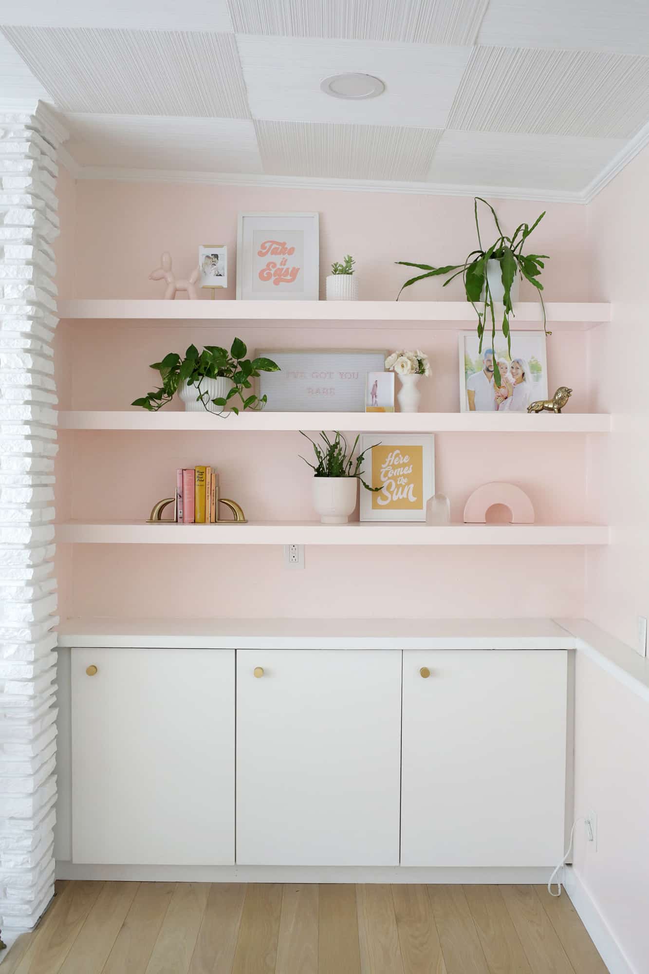 shelf decor on 3 pink built in shelves