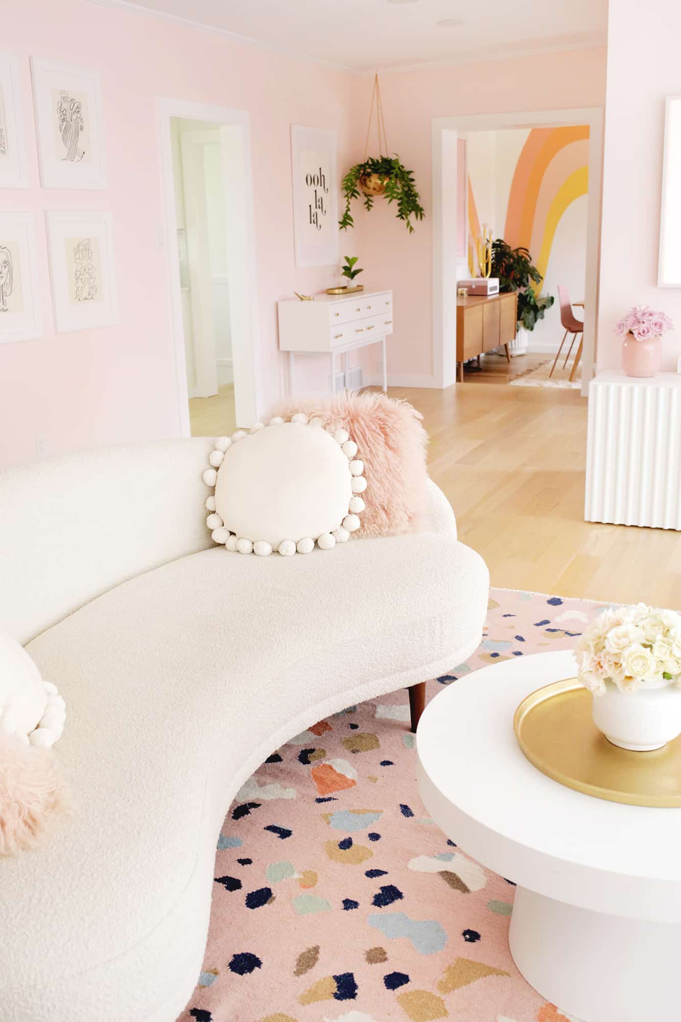 white boucle couch with pink pillows
