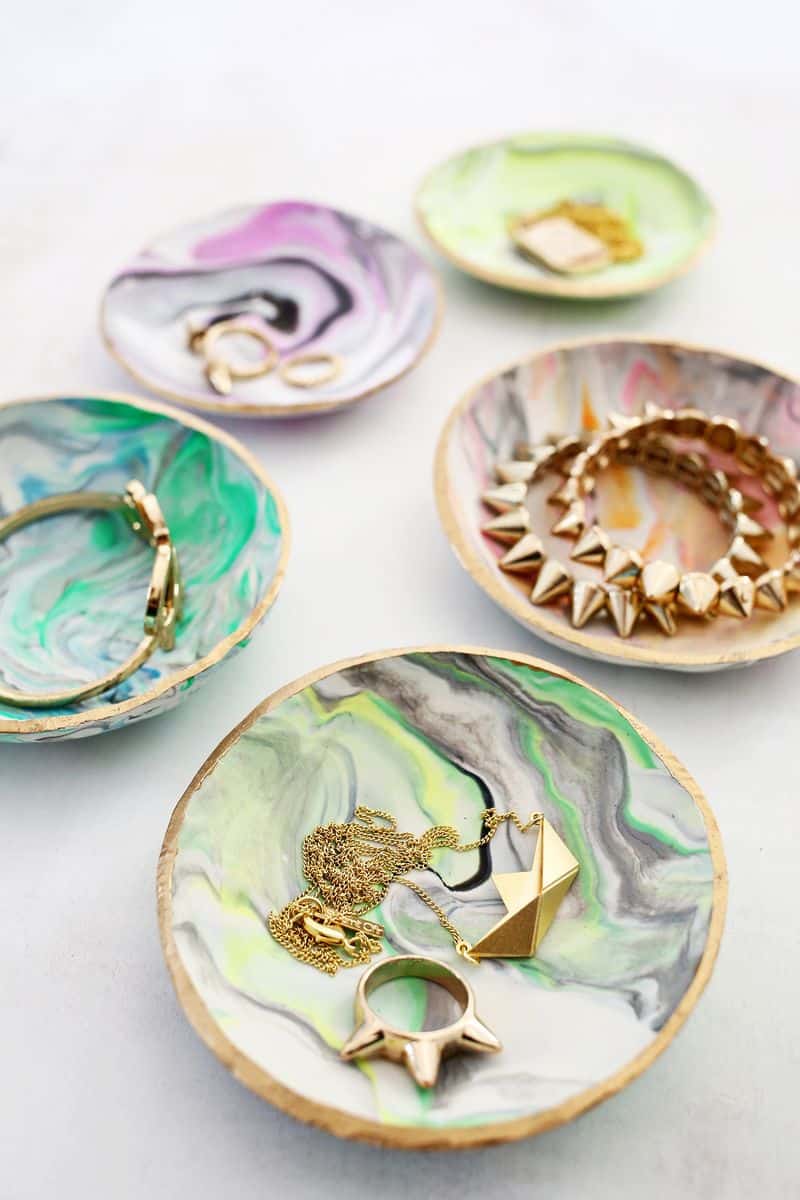 5 marbled clay ring dishes with jewelry in them