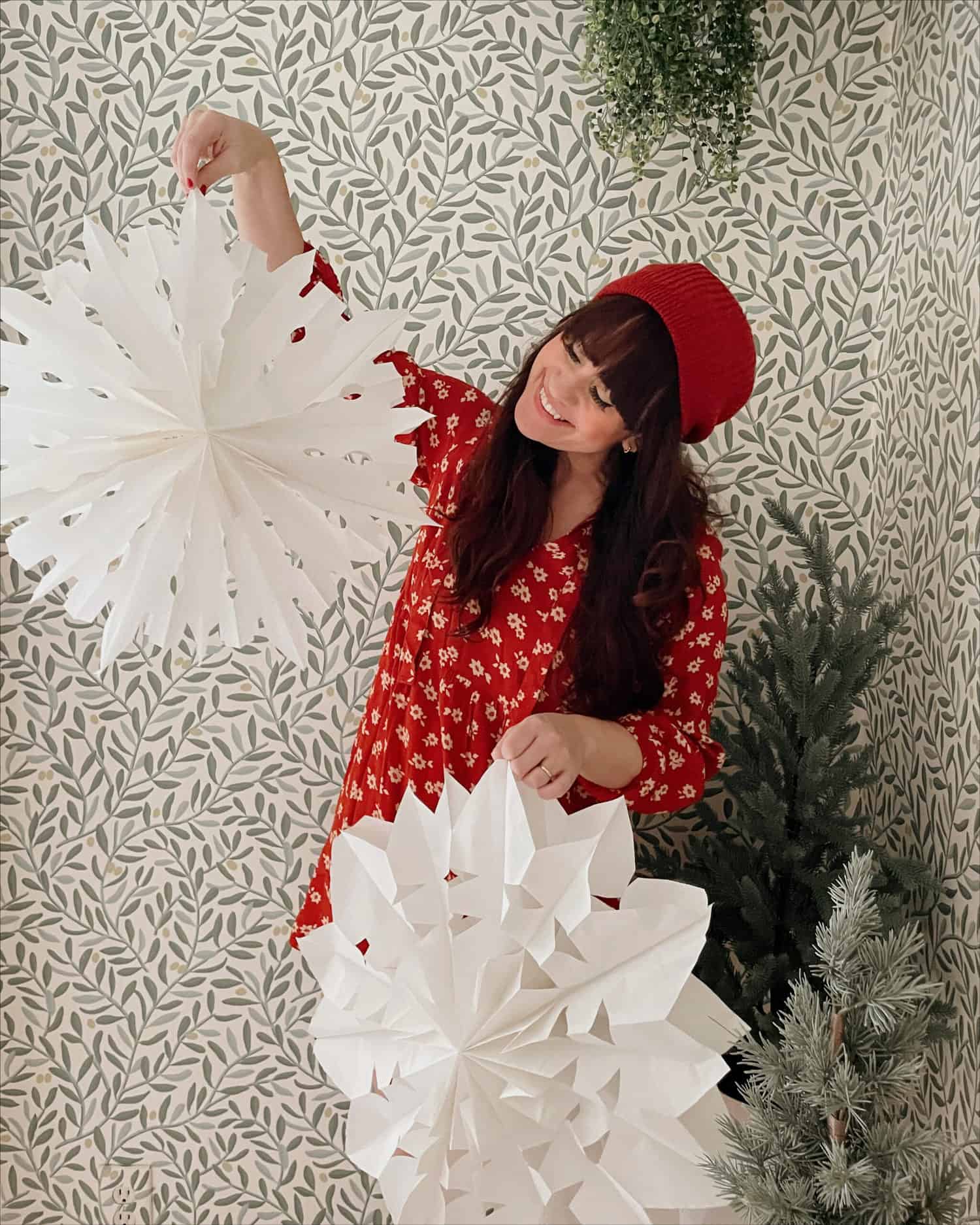 woman holding paper snowflakes