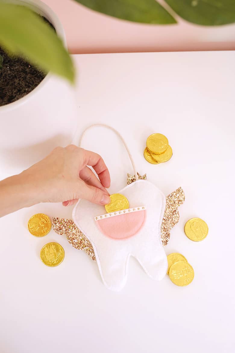 tooth fairy pillow surrounded by chocolate gold coins