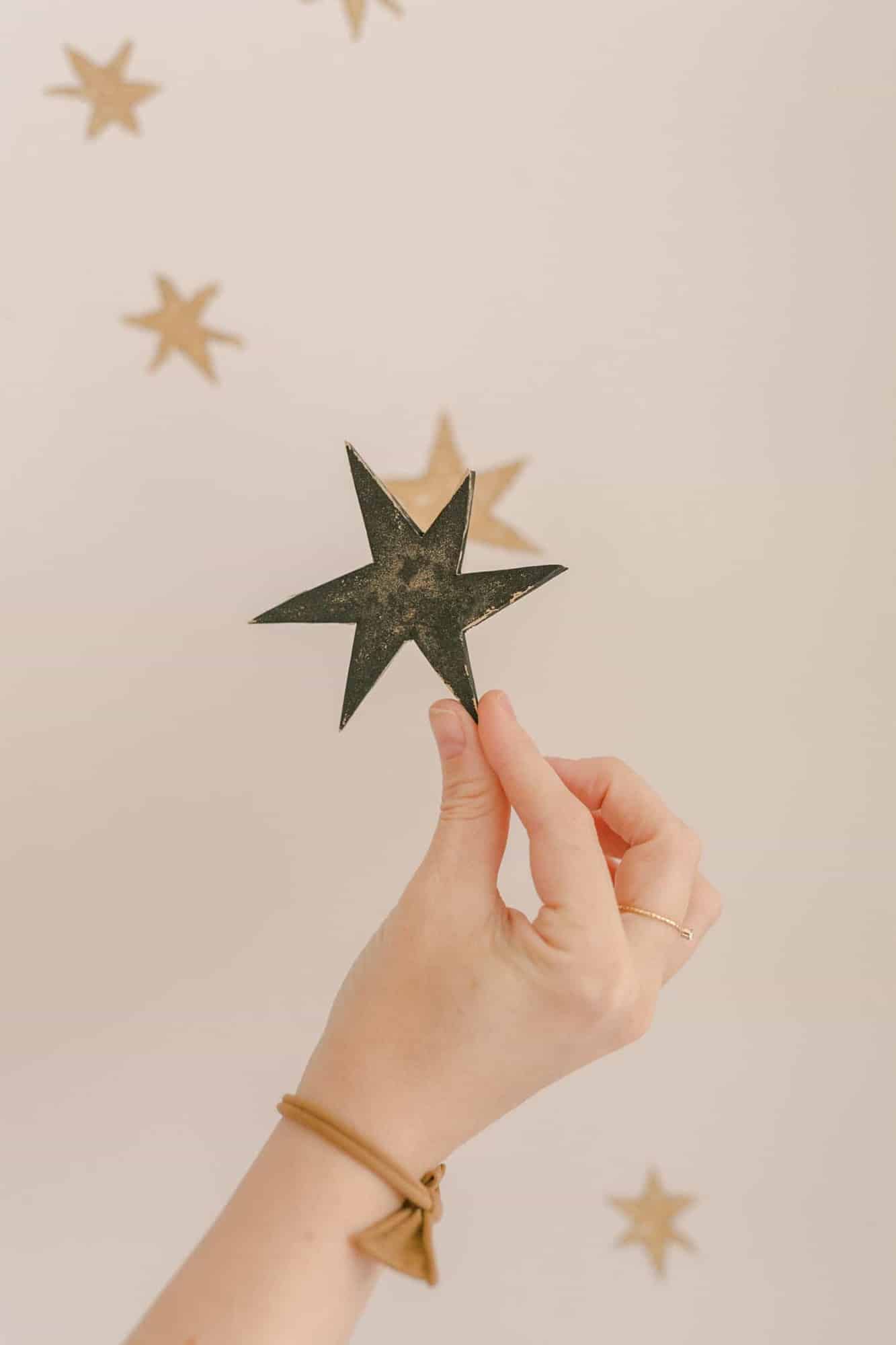 a woman holding a star stencil 