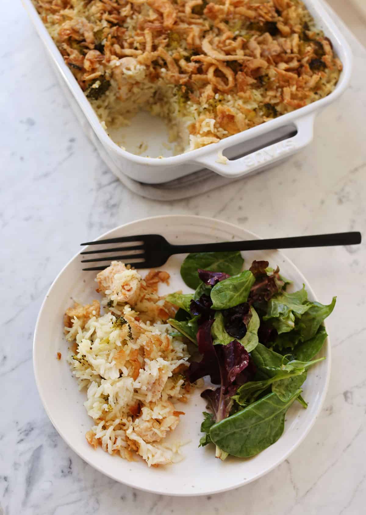 plate with chicken and rice casserole and salad