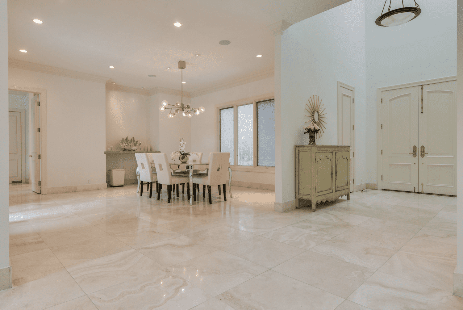 open floor plan view of dining room and front door with white tile floors