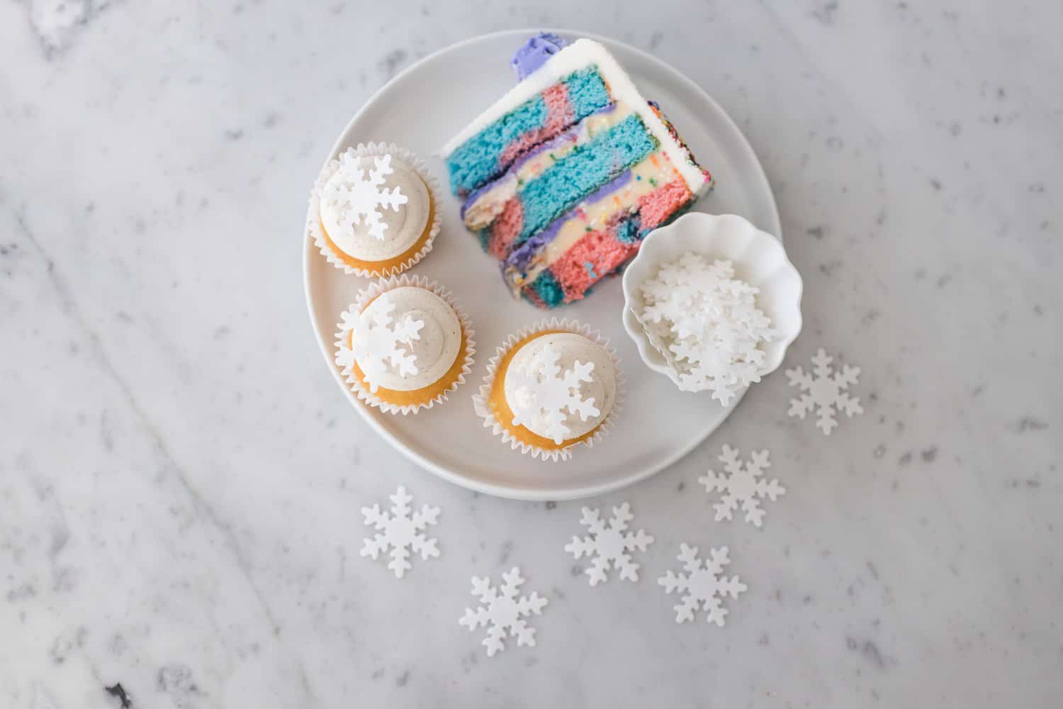 slice of birthday cake and snowflake cupcakes 