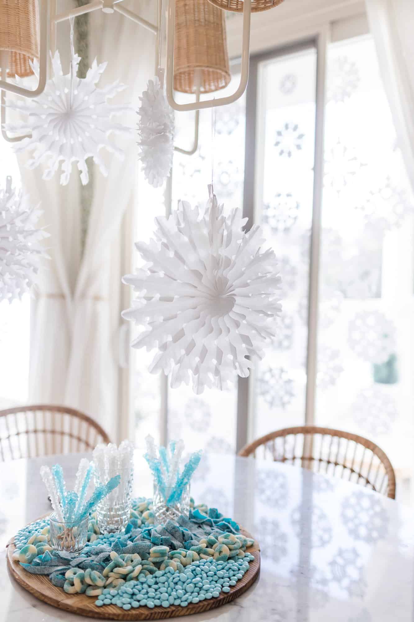 paper snowflakes hanging above a candy tray
