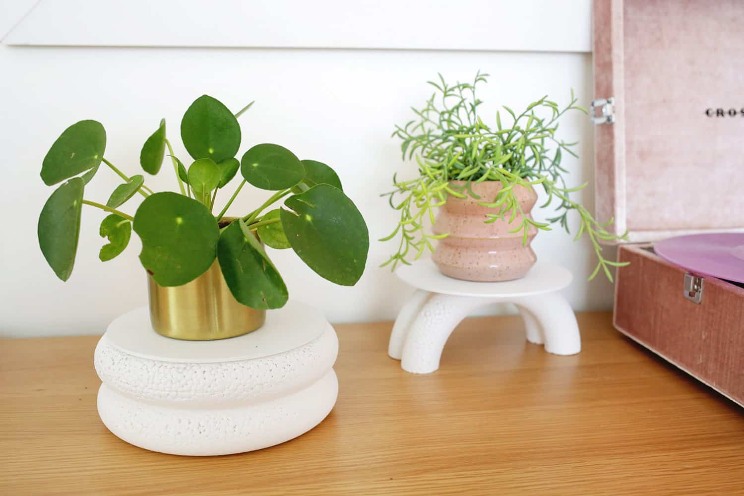 two DIY plant stands on a table