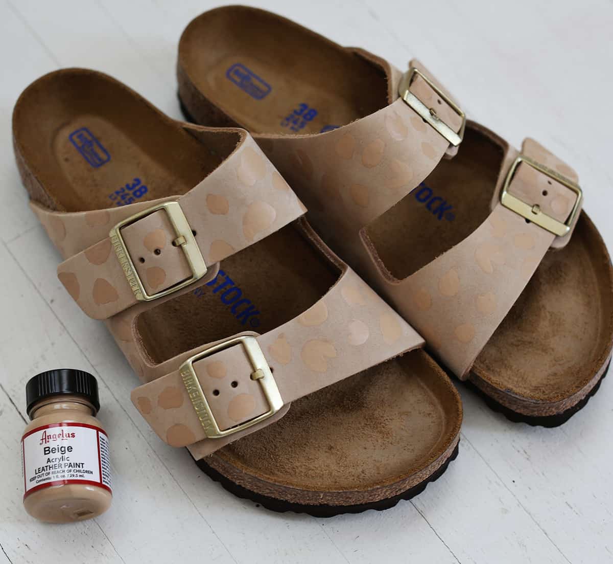 Leather acrylic paint bottle next to the slippers