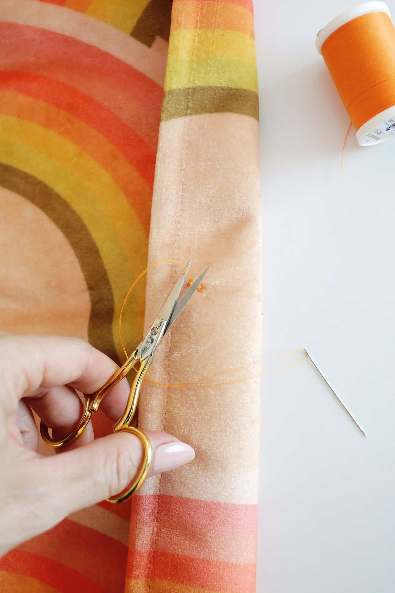 cutting off the thread on a button being sewn