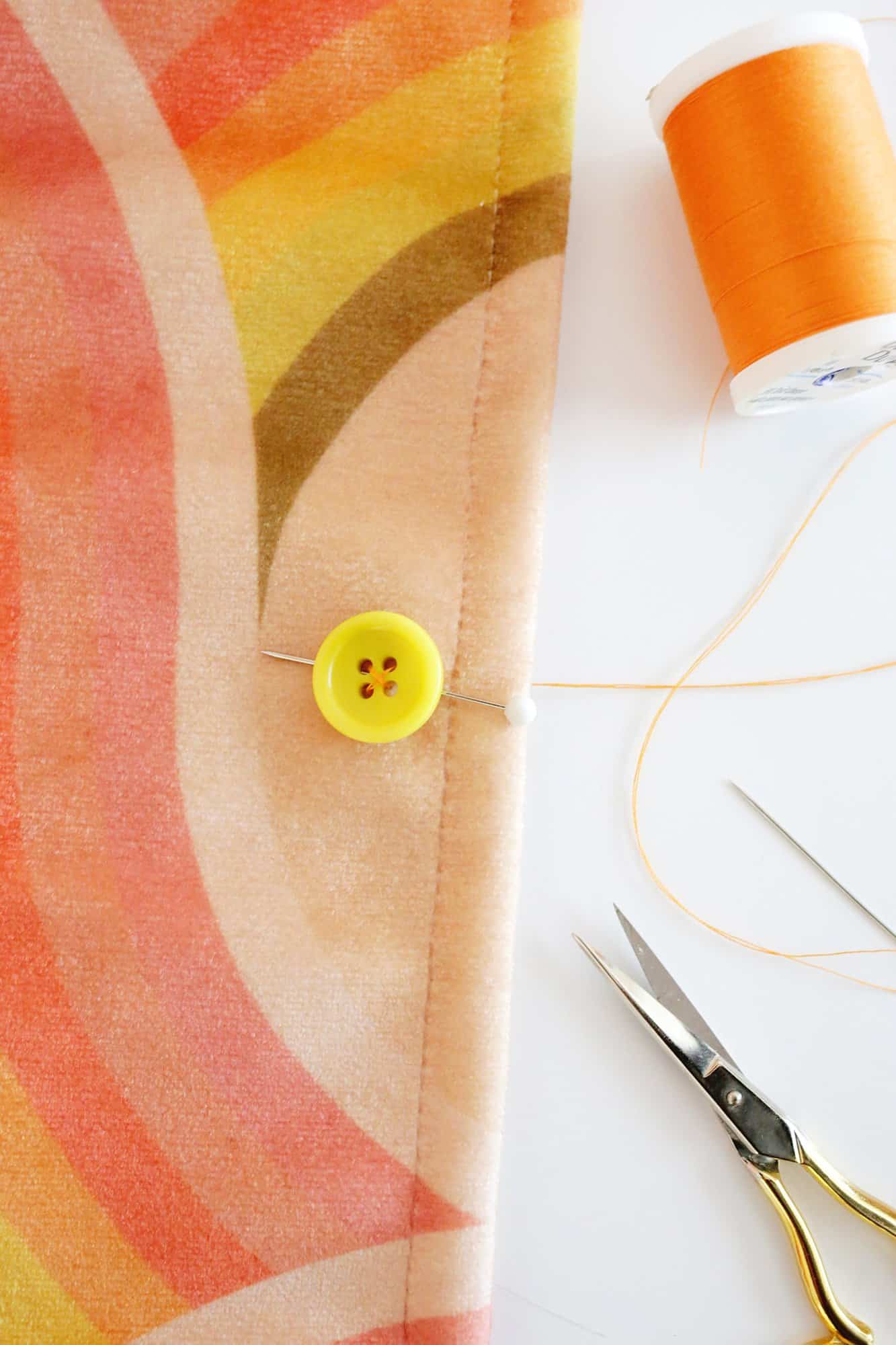 sewing a button onto fabric