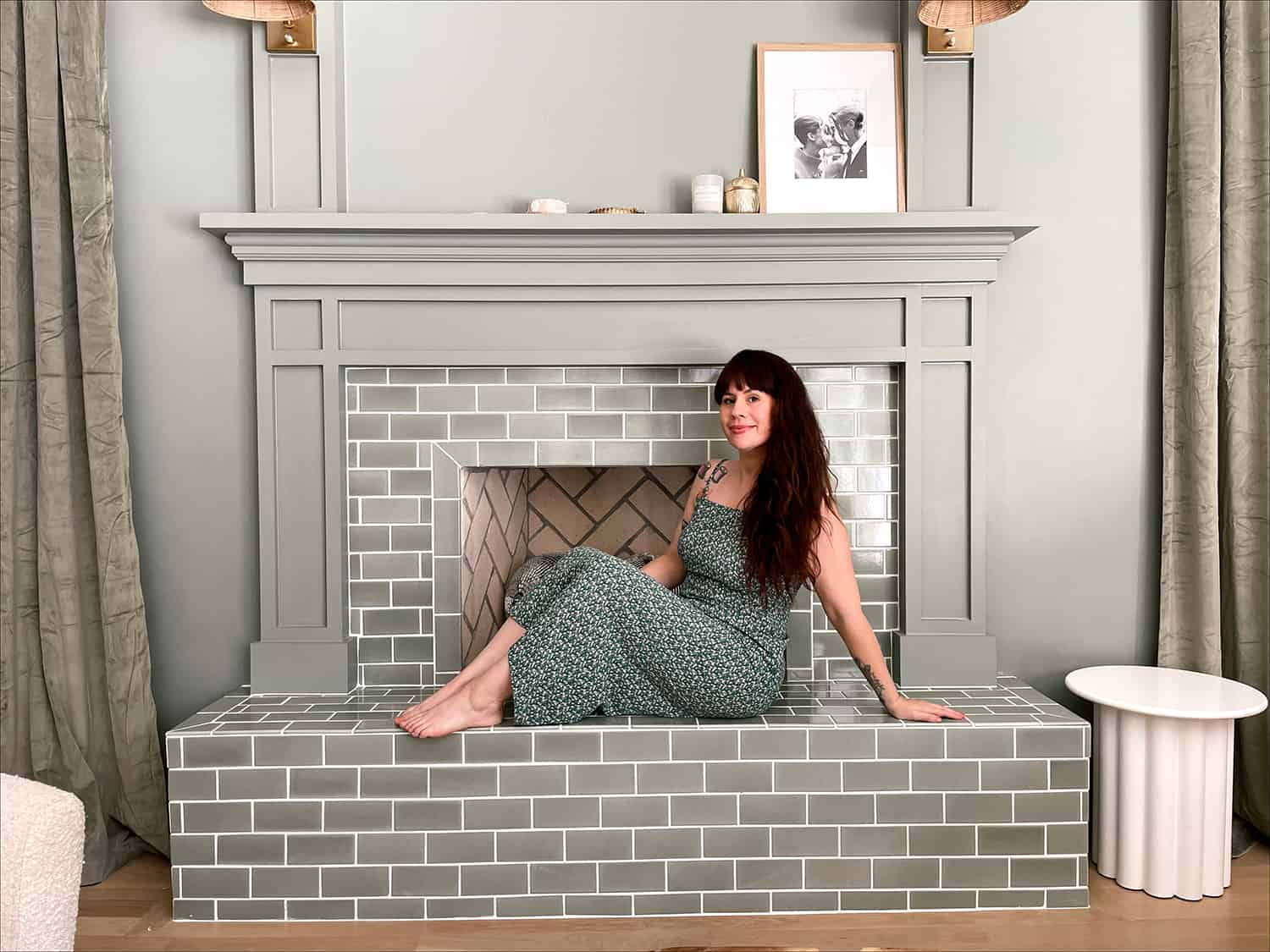 Woman sitting on green fireplace