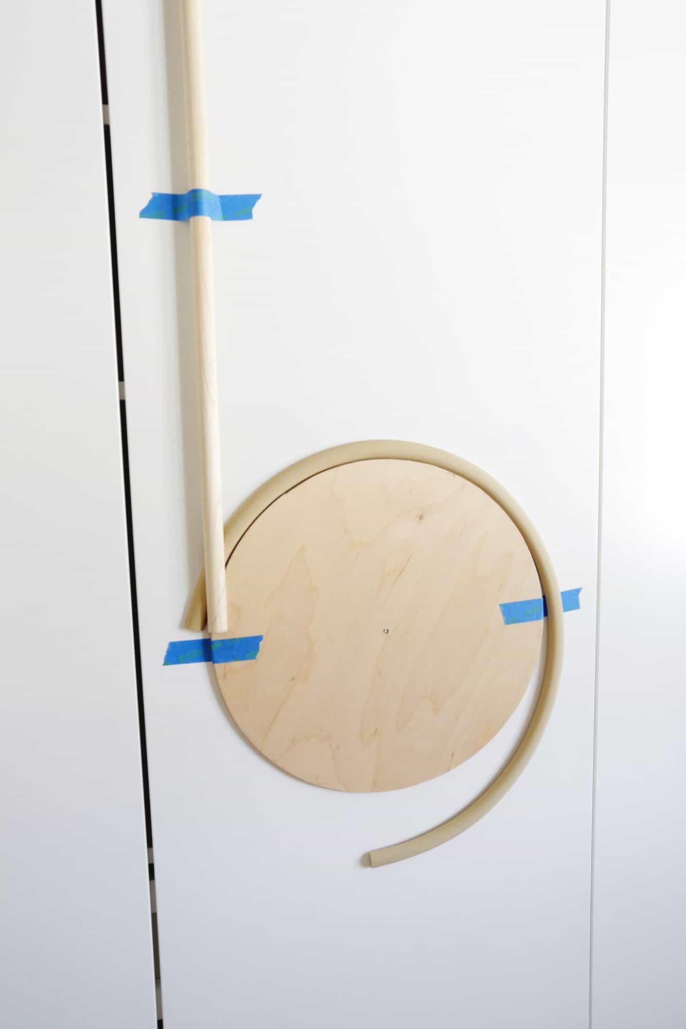 wooden circle guide with flexible trim draped over it