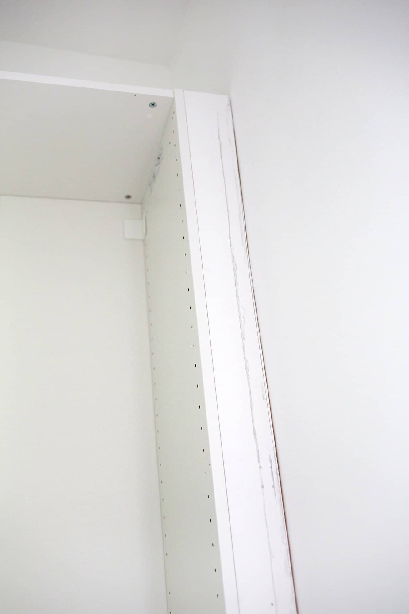 board filling in gap between closet and wall