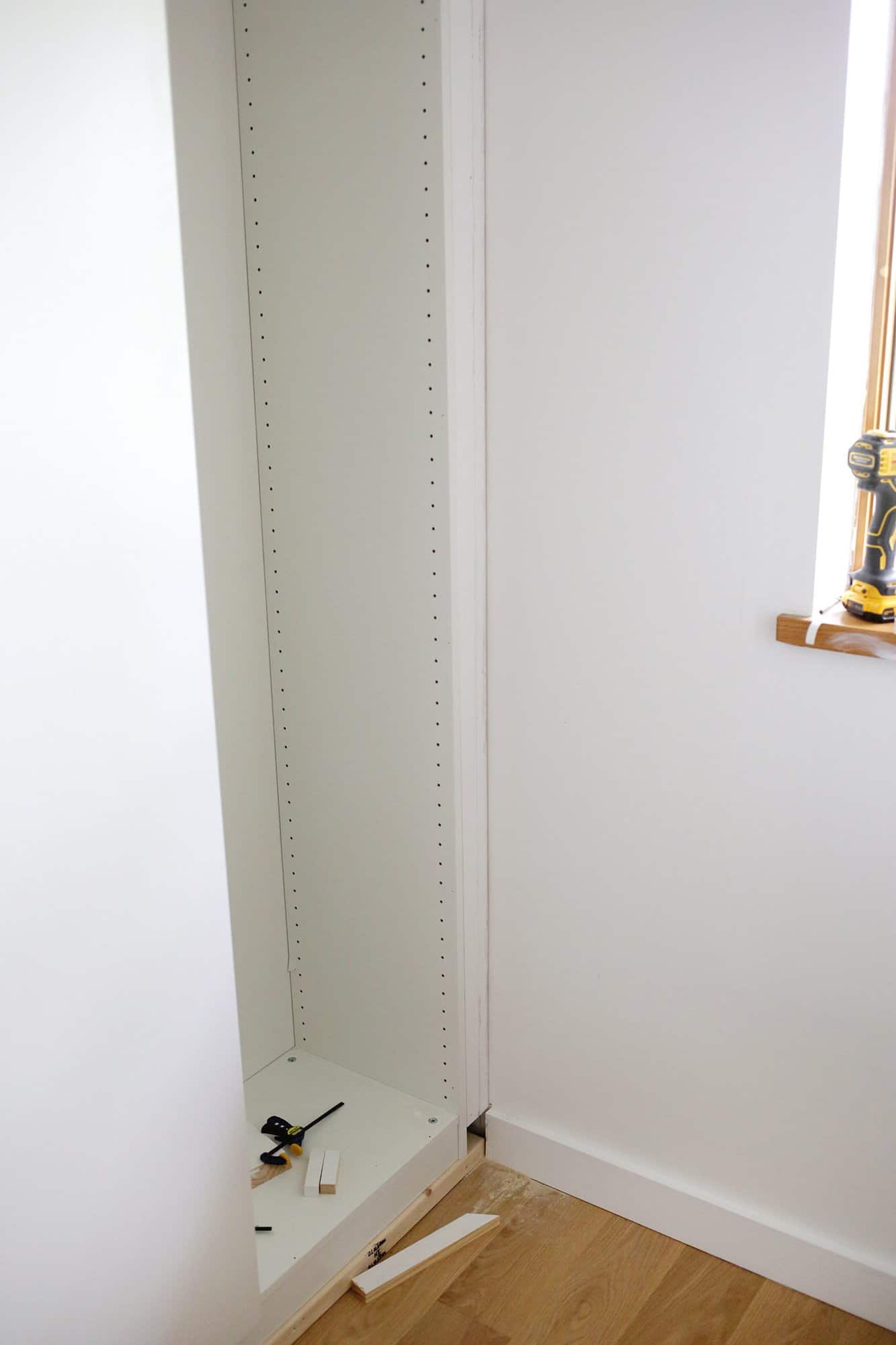 board filling in gap between closet and wall