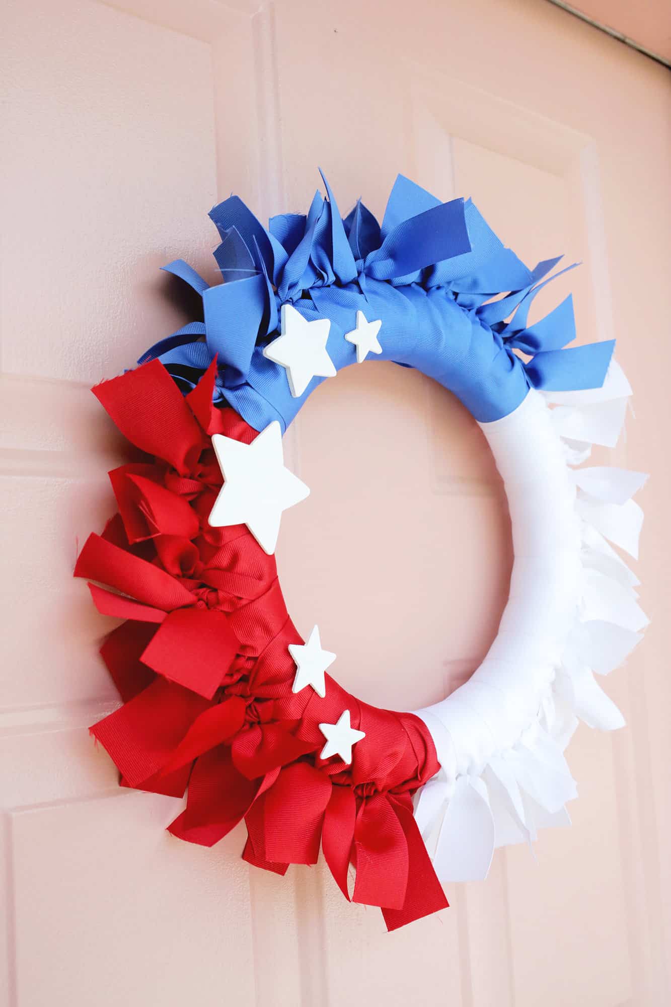 closeup of 4th of july ribbon wreath on door