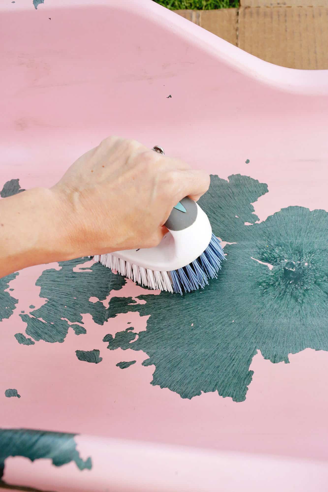 scrubbing plastic slide with a scrub brush