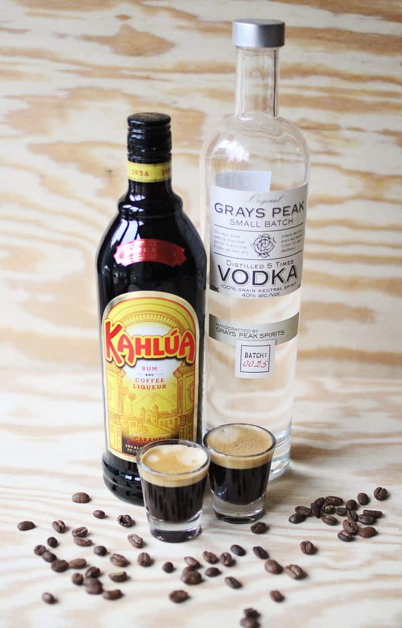 Kahlua, vodka and espresso sit on a counter.