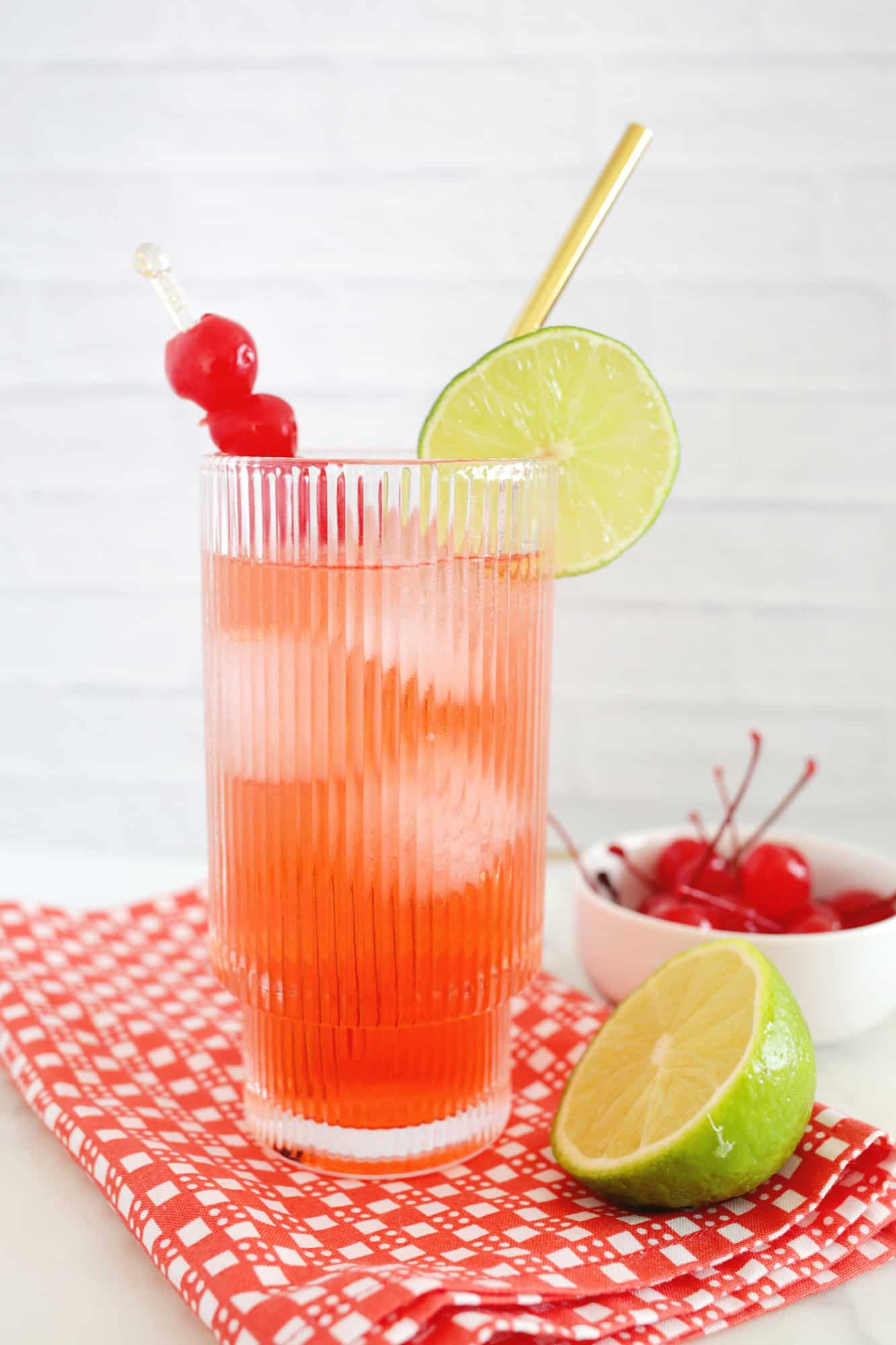 Classic Shirley Temple mocktail with lime wedge and cherry