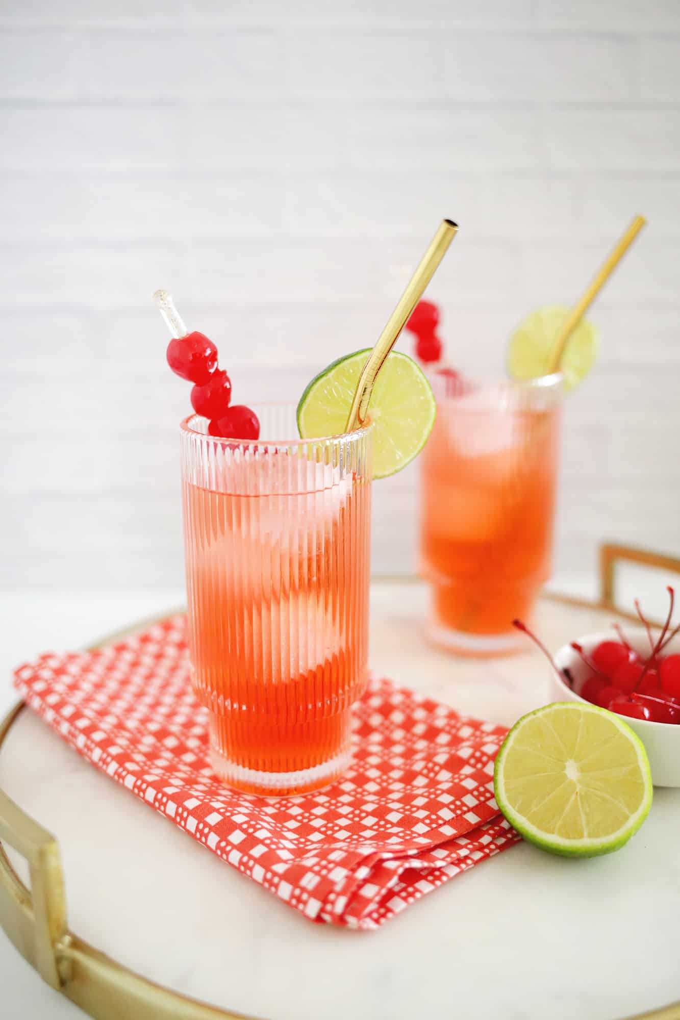 Classic Shirley Temple mocktail with lime wedge and cherry