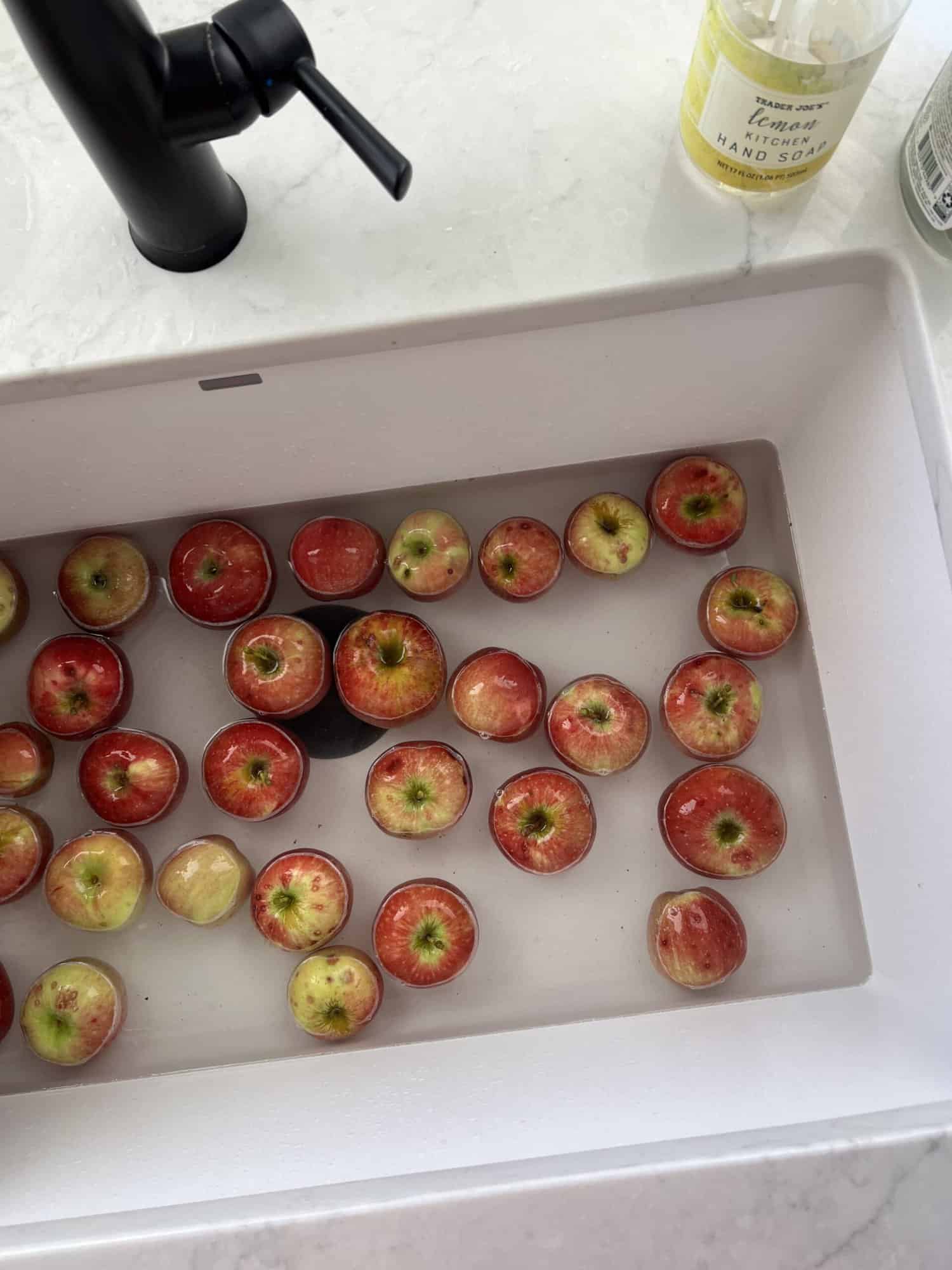 Apples floating in kitchen sink