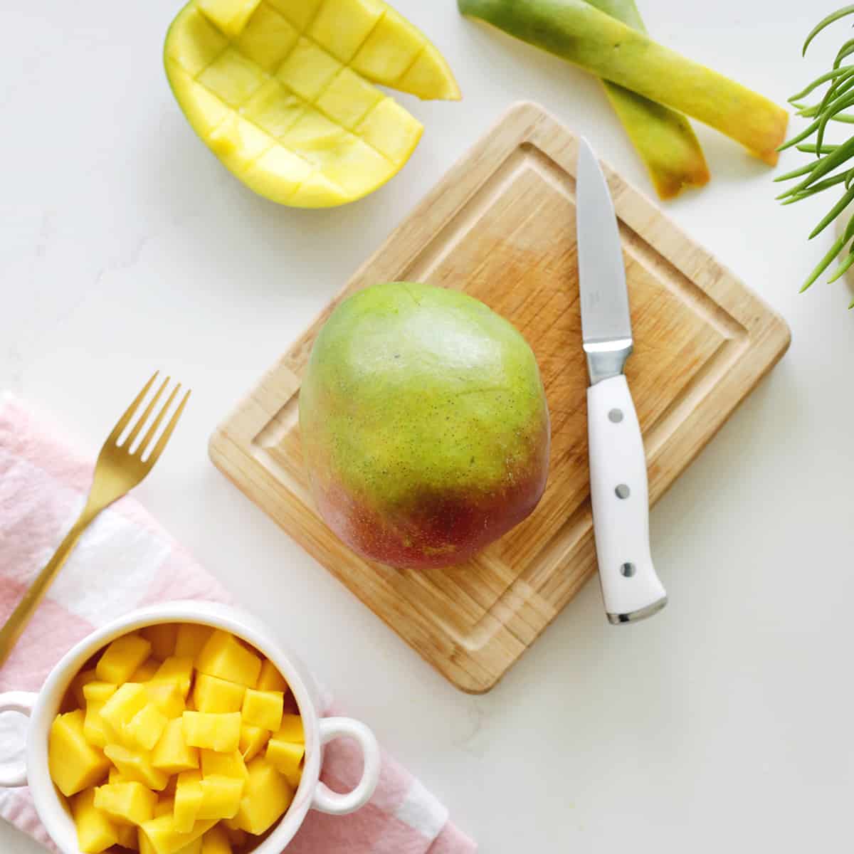 Mango and diced mango on cutting board