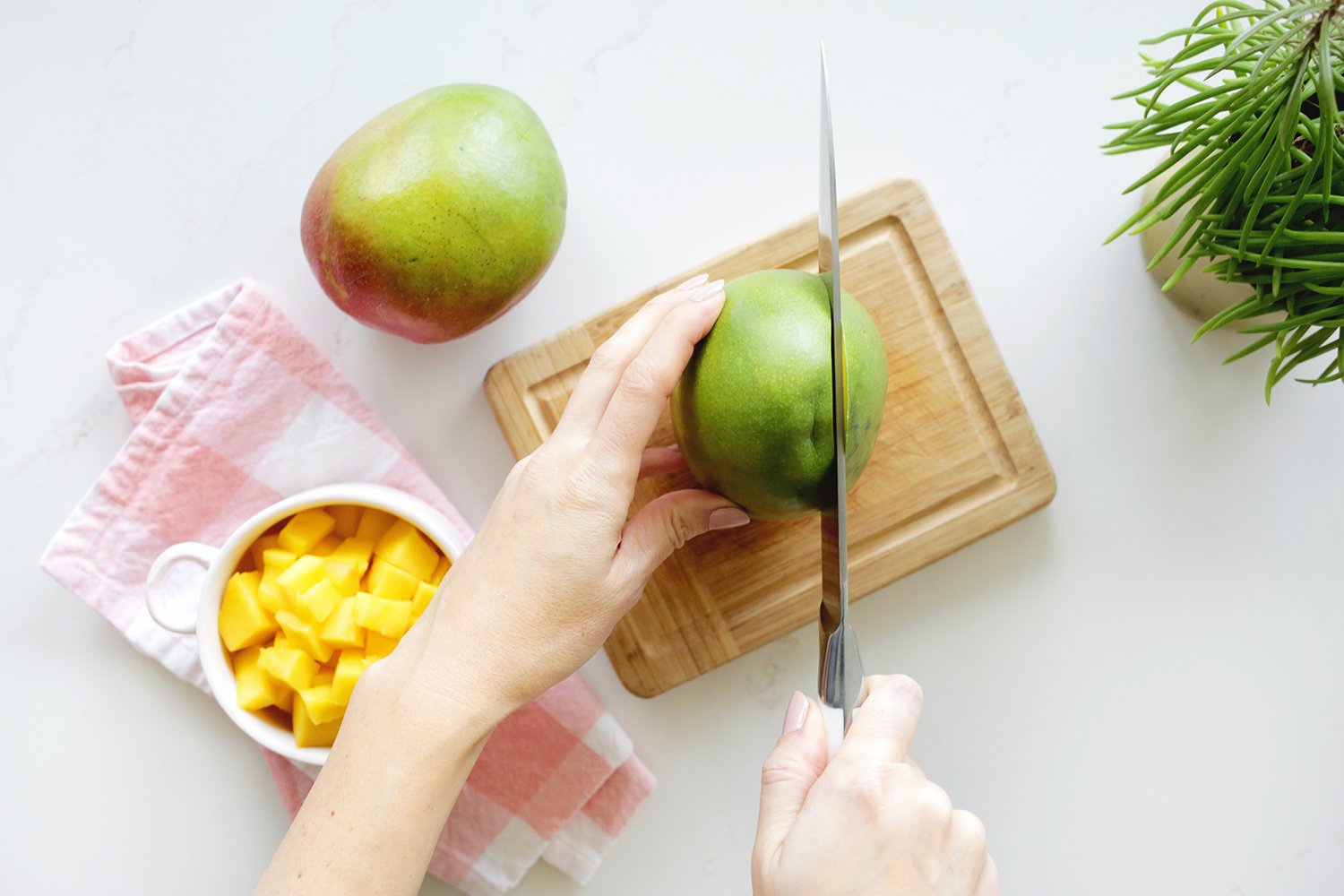 cutting mango on cutting board
